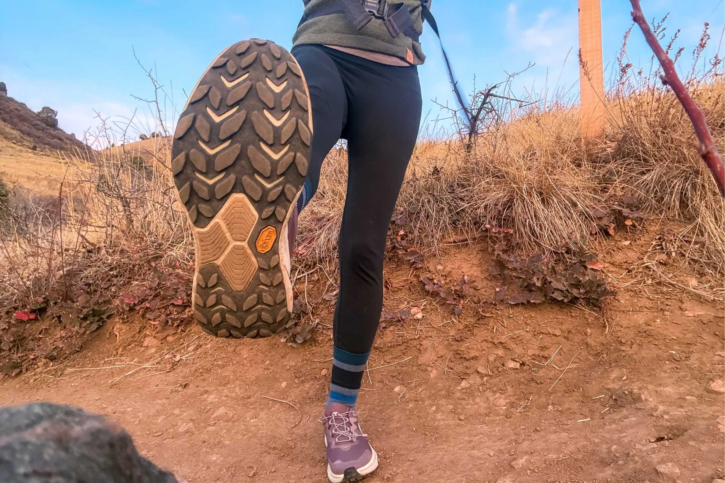 Woman lifting foot to show HOKA Transport 2 outsole