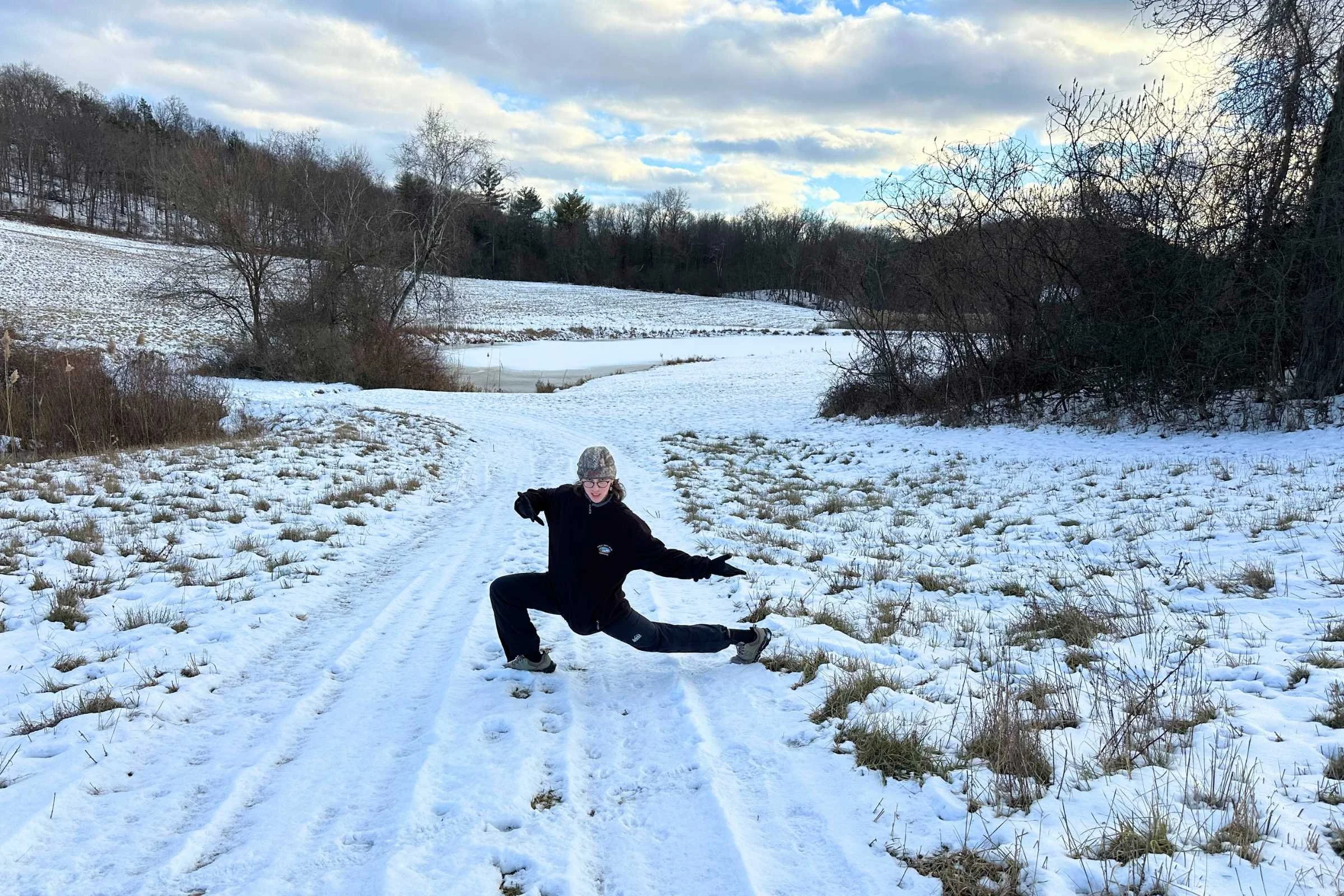 REI Co-op XeroCloud rain pants worn on trail in snowy weather.