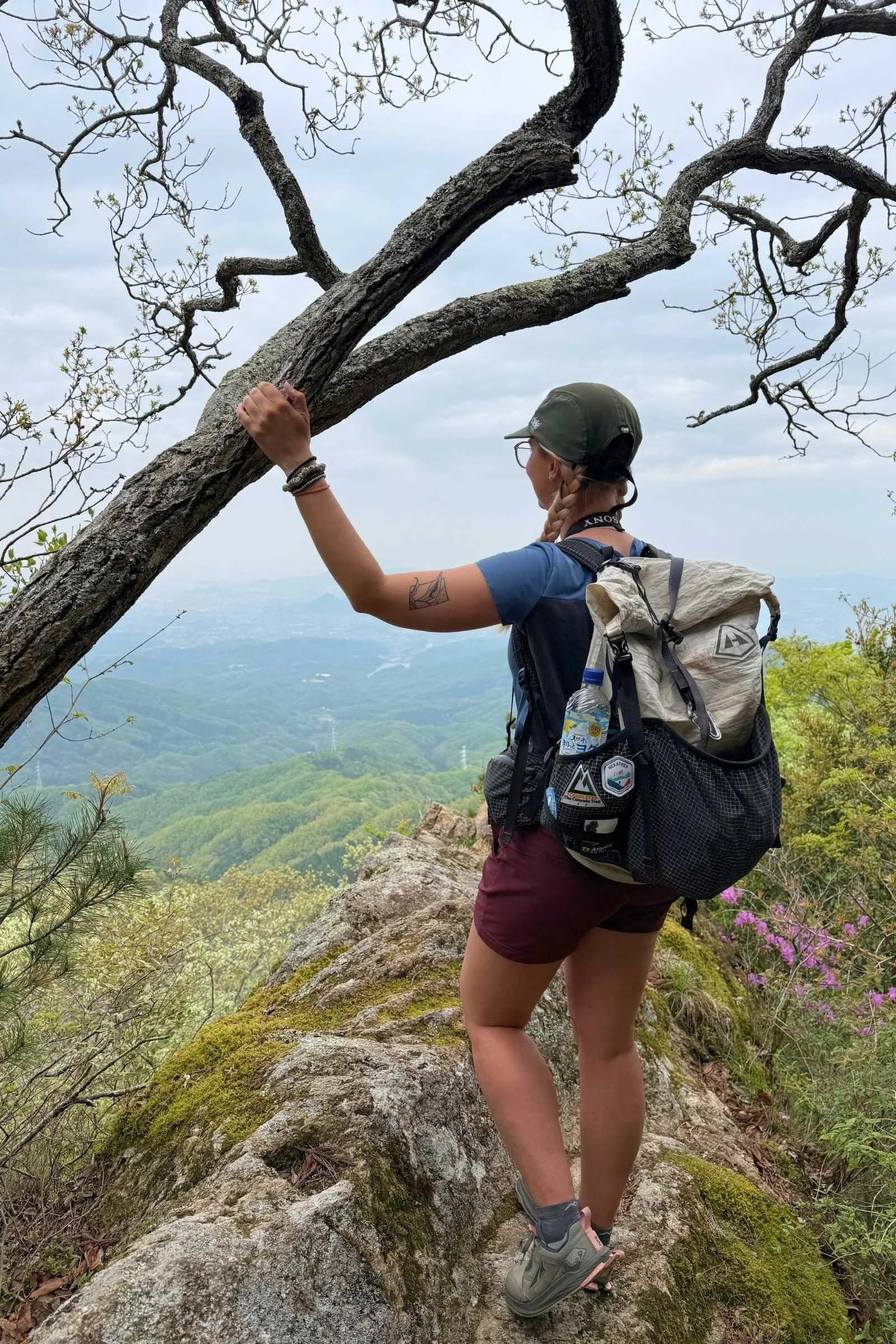 A woman stands on a mountain in Japan