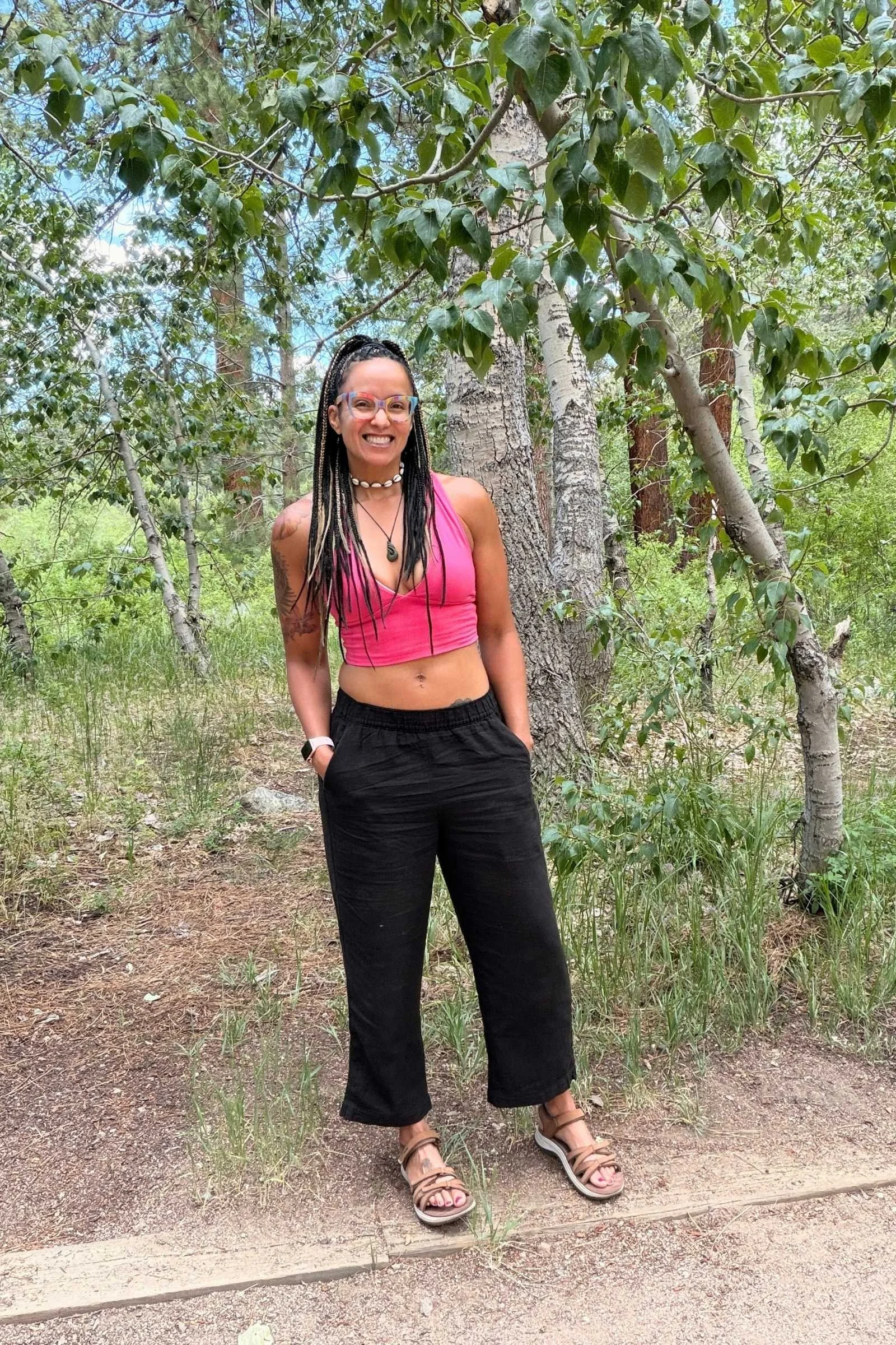 Woman wearing Patagonia Garden Island travel pants in black at a campsite