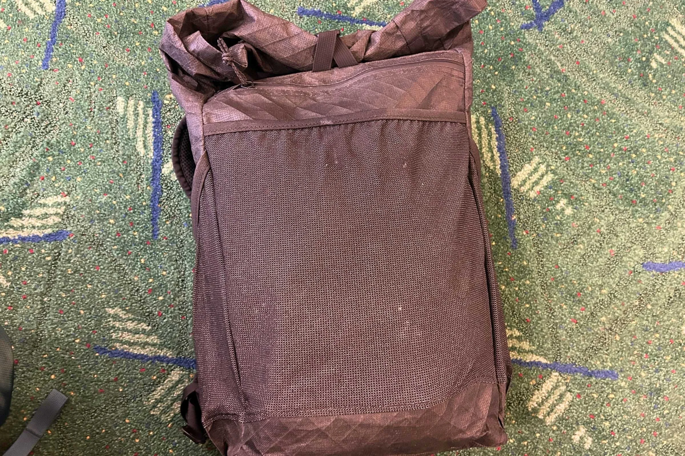 the ula ultra node 20l backpack on the ground at an airport
