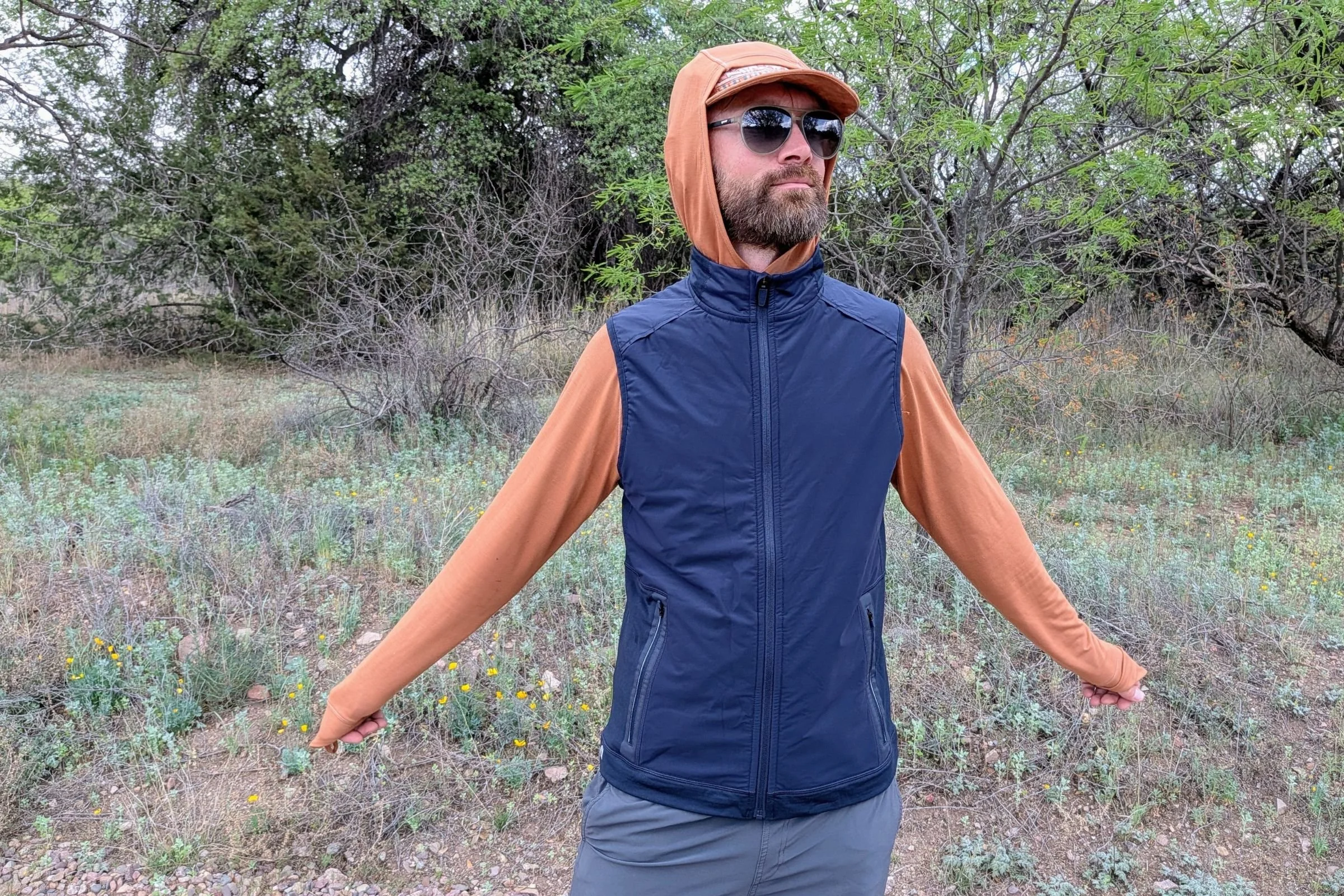 Man wearing a dark blue Smartwool Active Fleece Wind Insulated vest.