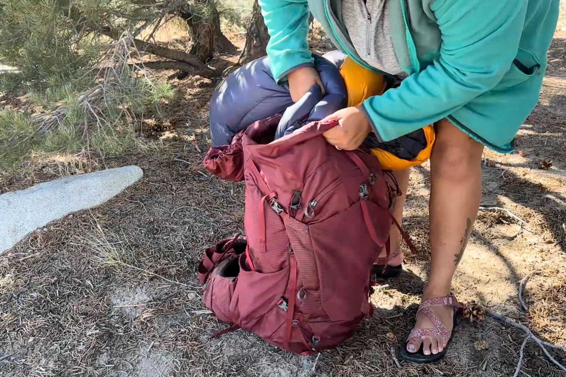 Packing away a REI Co-op Magma 30 into a 60 L Gregory pack.