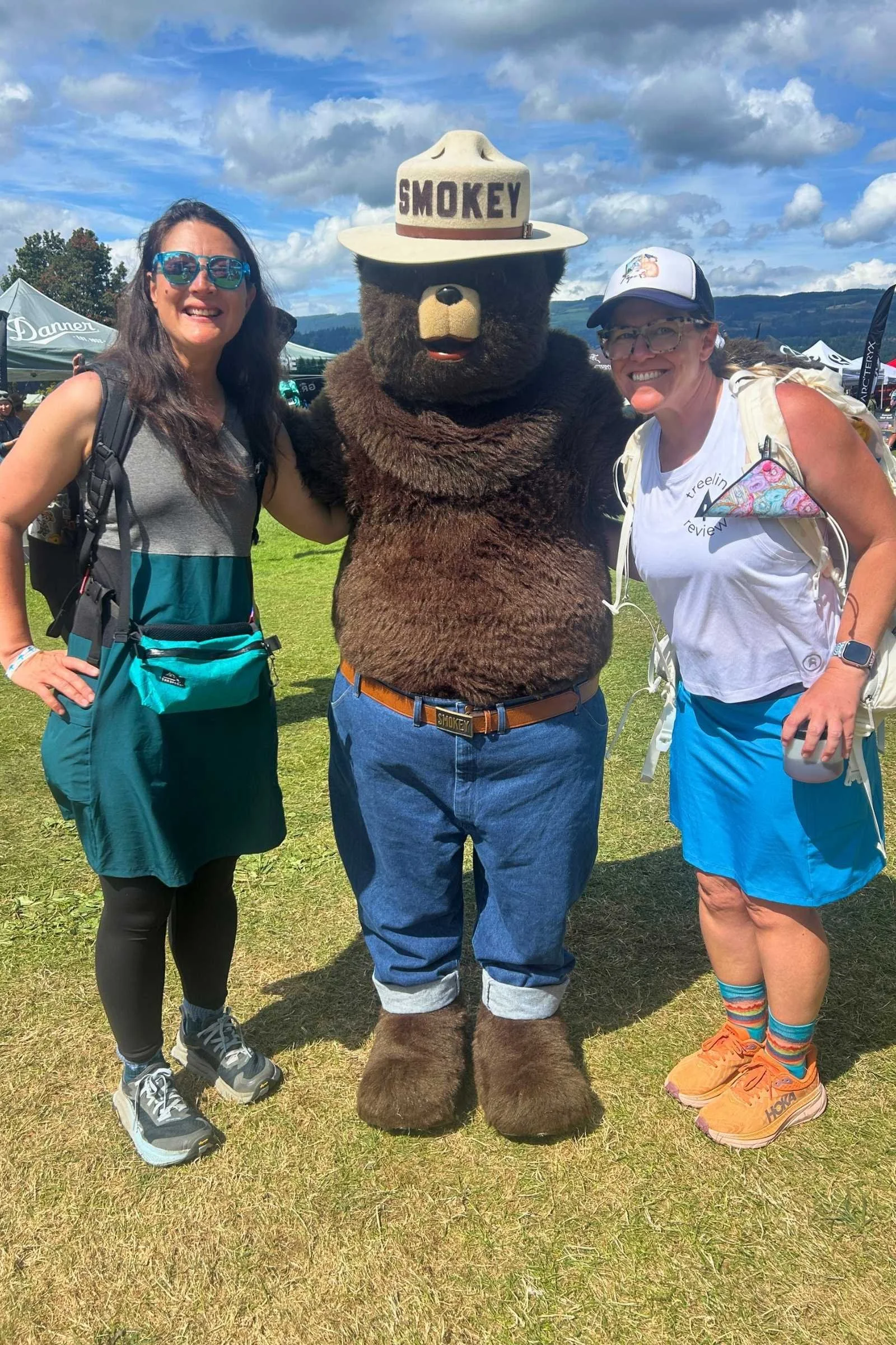the author (left), someone in a smokey the bear costume in the middle, and treeline writer Socks on the right