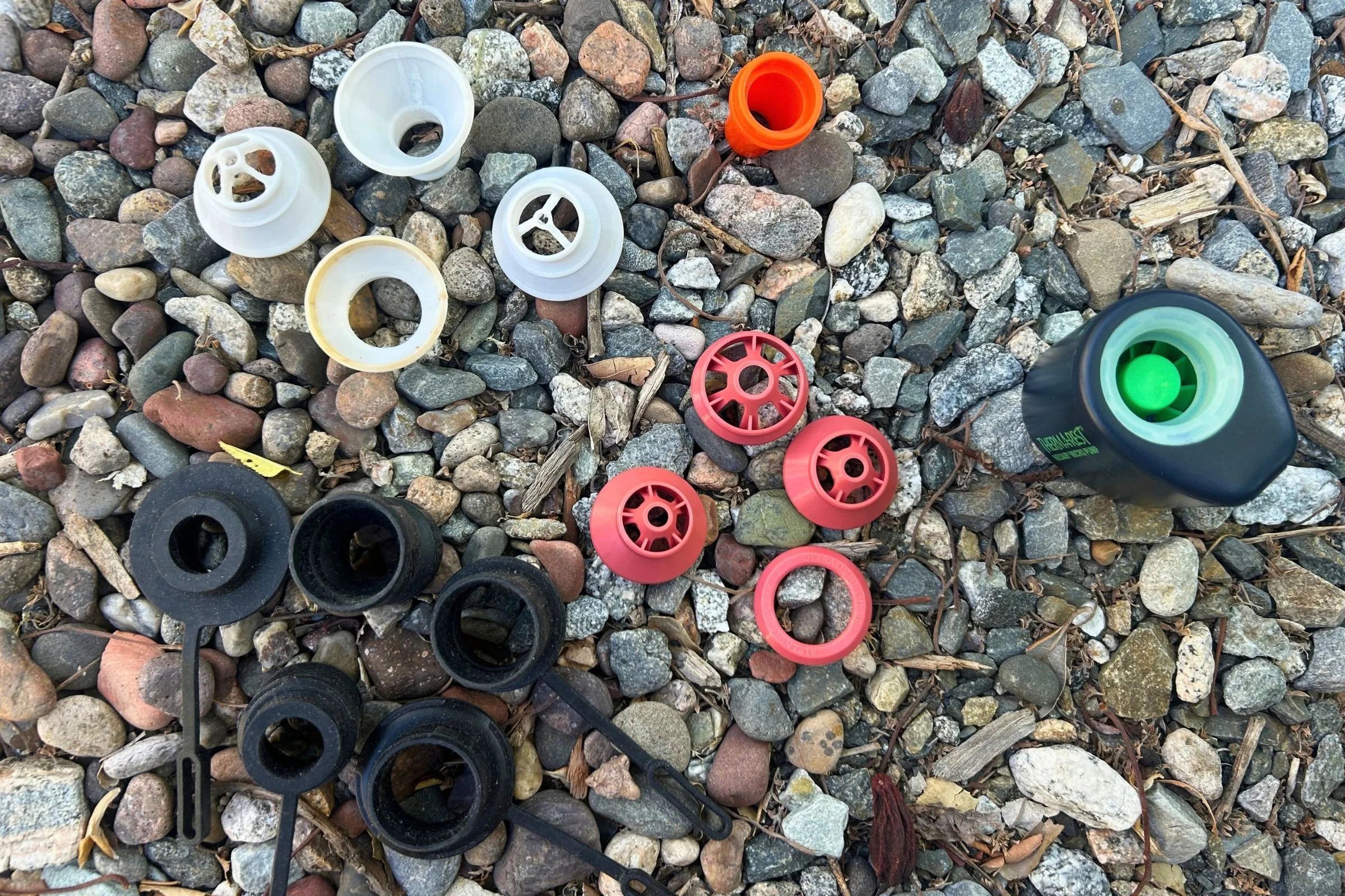 Sleeping pad inflator valves displayed n a rock background