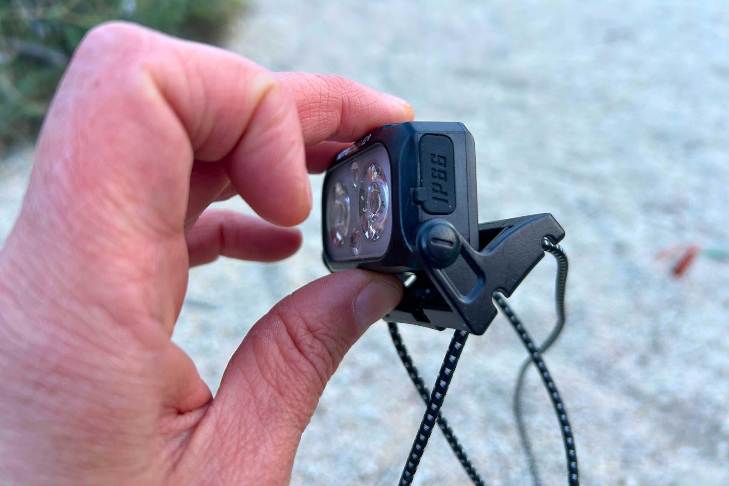 Close-up of the Nitecore NU25 MCT headlamp showing the adjustable tilt angle mechanism.