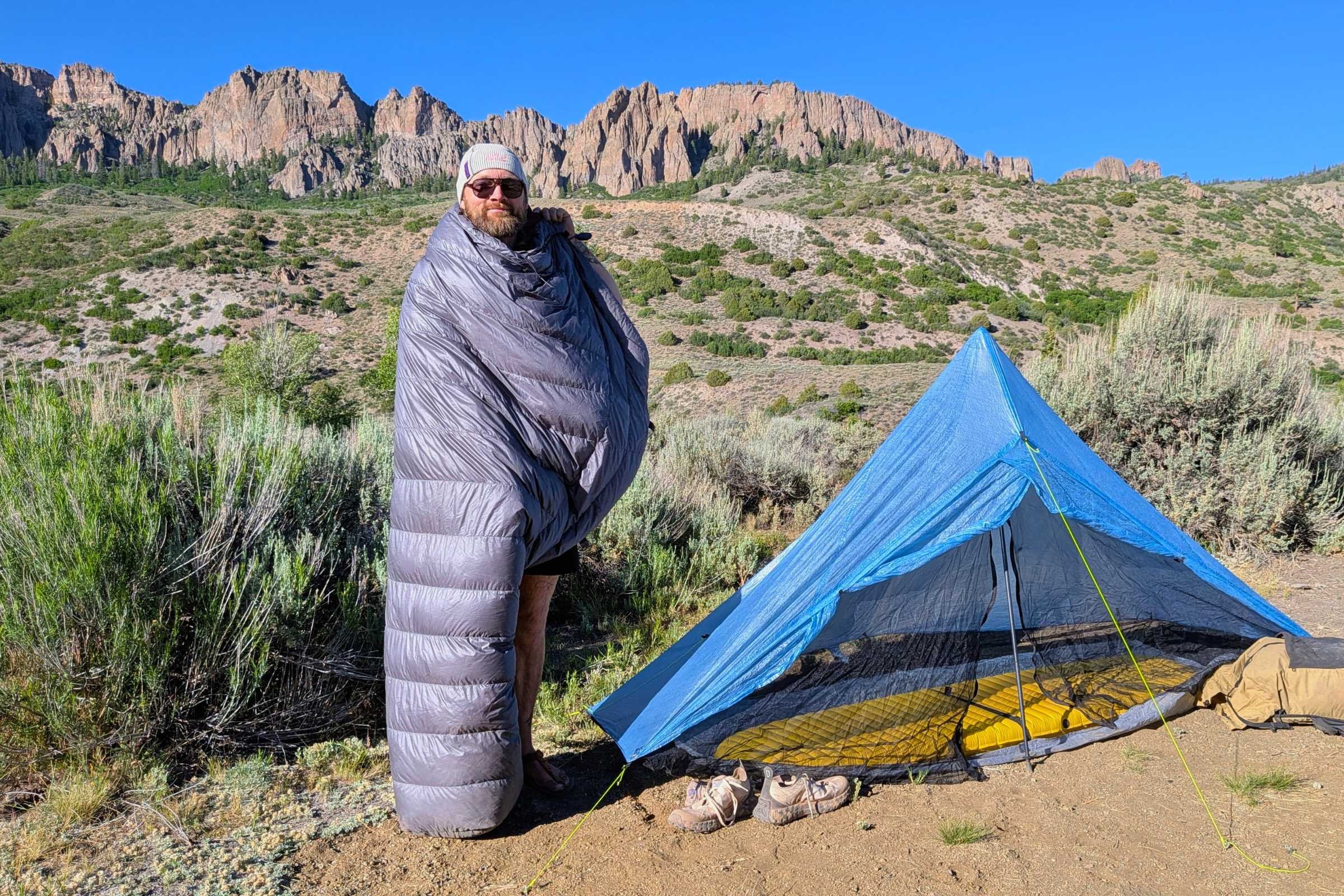 Outdoor Vitals StormLoft 15 Down TopQuilt — man standing beside a tent