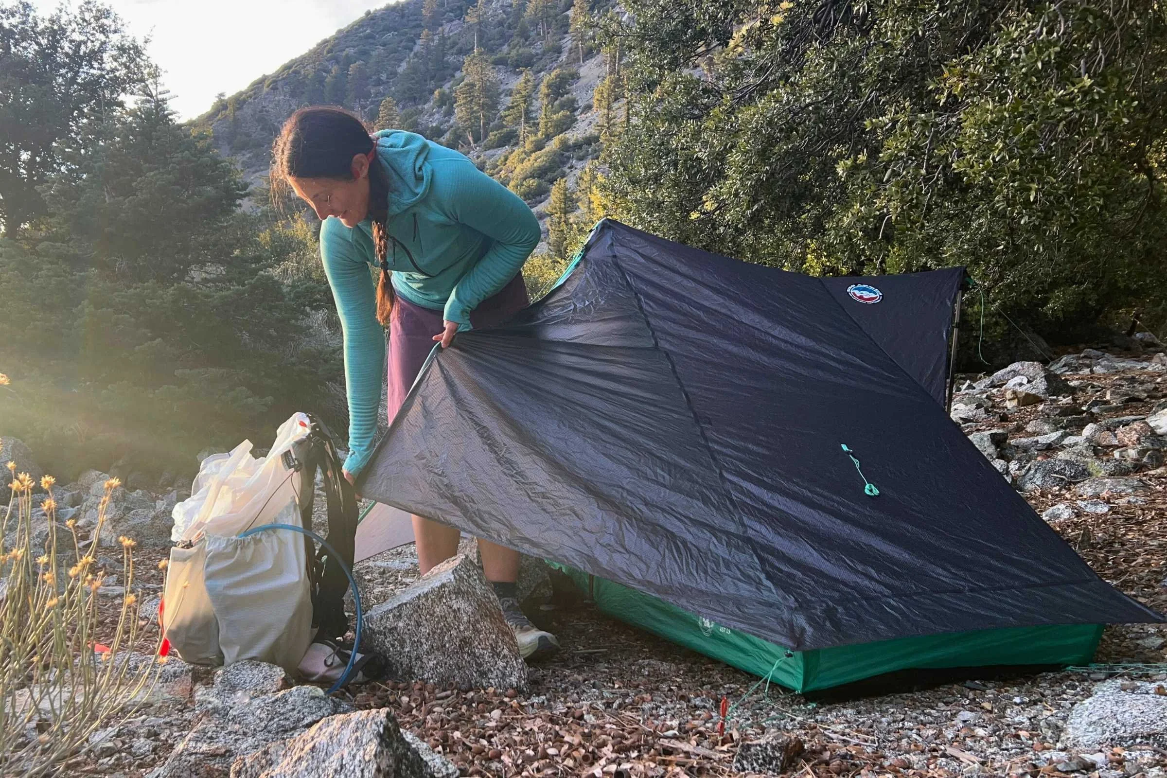 Backpacker adjusting Big Agnes String Ridge VST tent at campsite