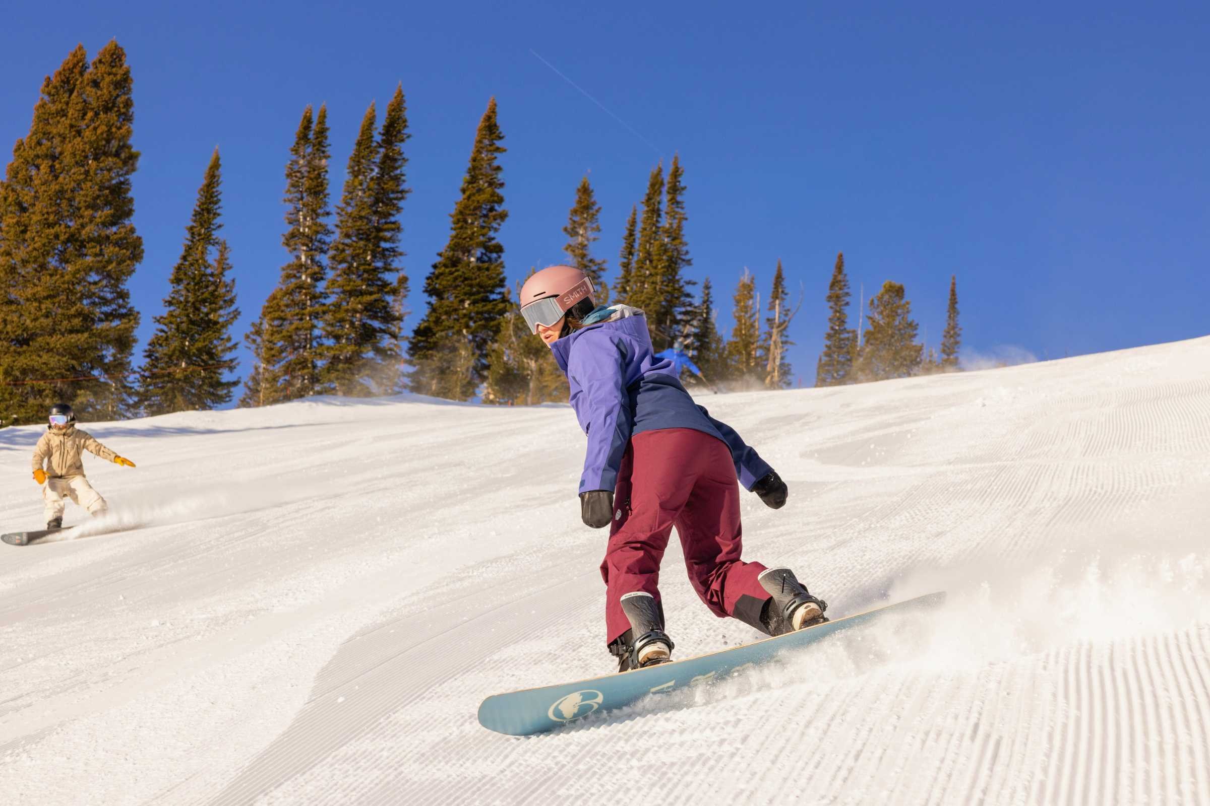 Snowboarder demonstrating jacket mobility and articulated design in the Stio Skyrider