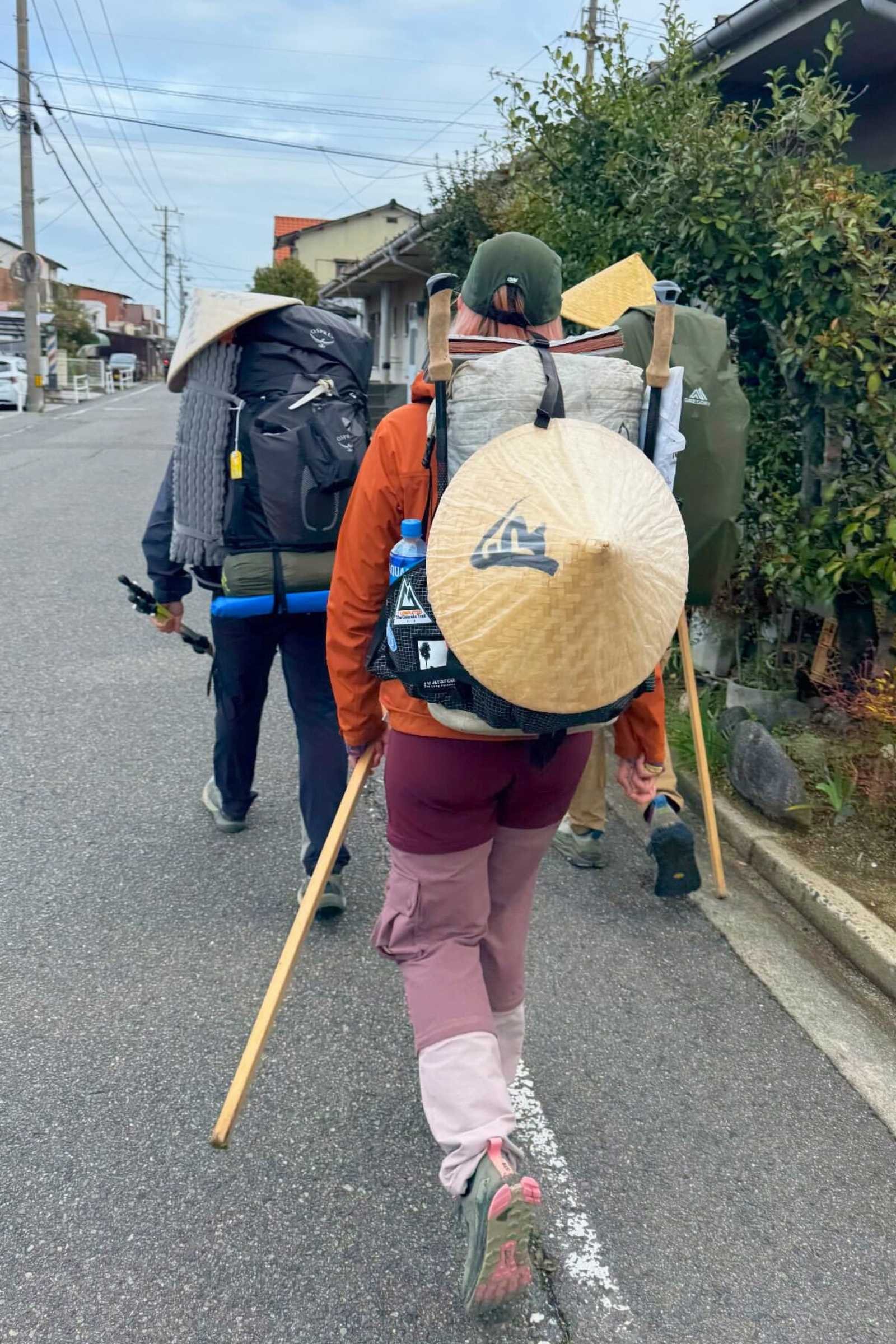 3 pilgrims walking through town