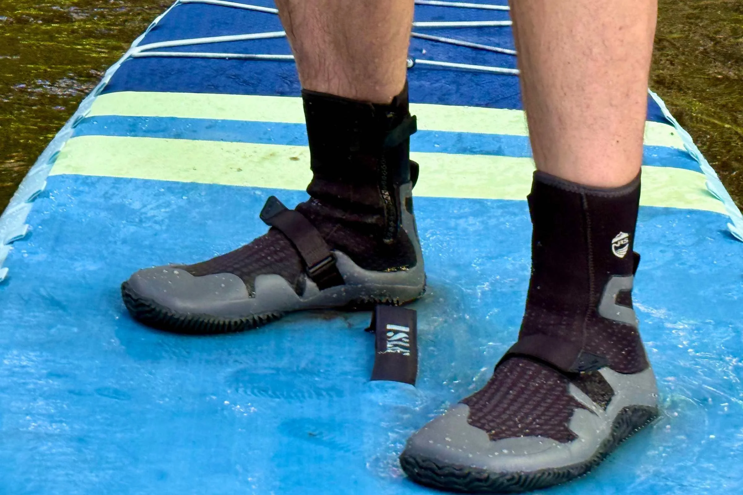 Person standing on a SUP wearing the NRS Paddle Wetshoe