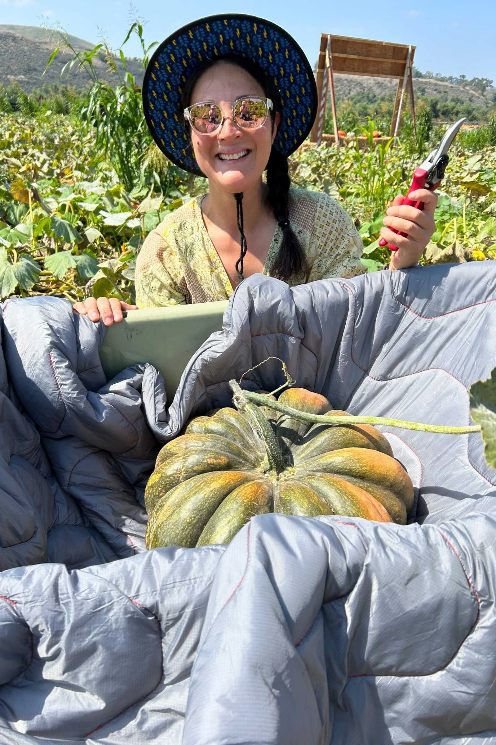 Cascade Mountain Tech blanket being used as paddint to protect a pumpkin from getting cut or scratched during a long wheelbarrow ride back the car