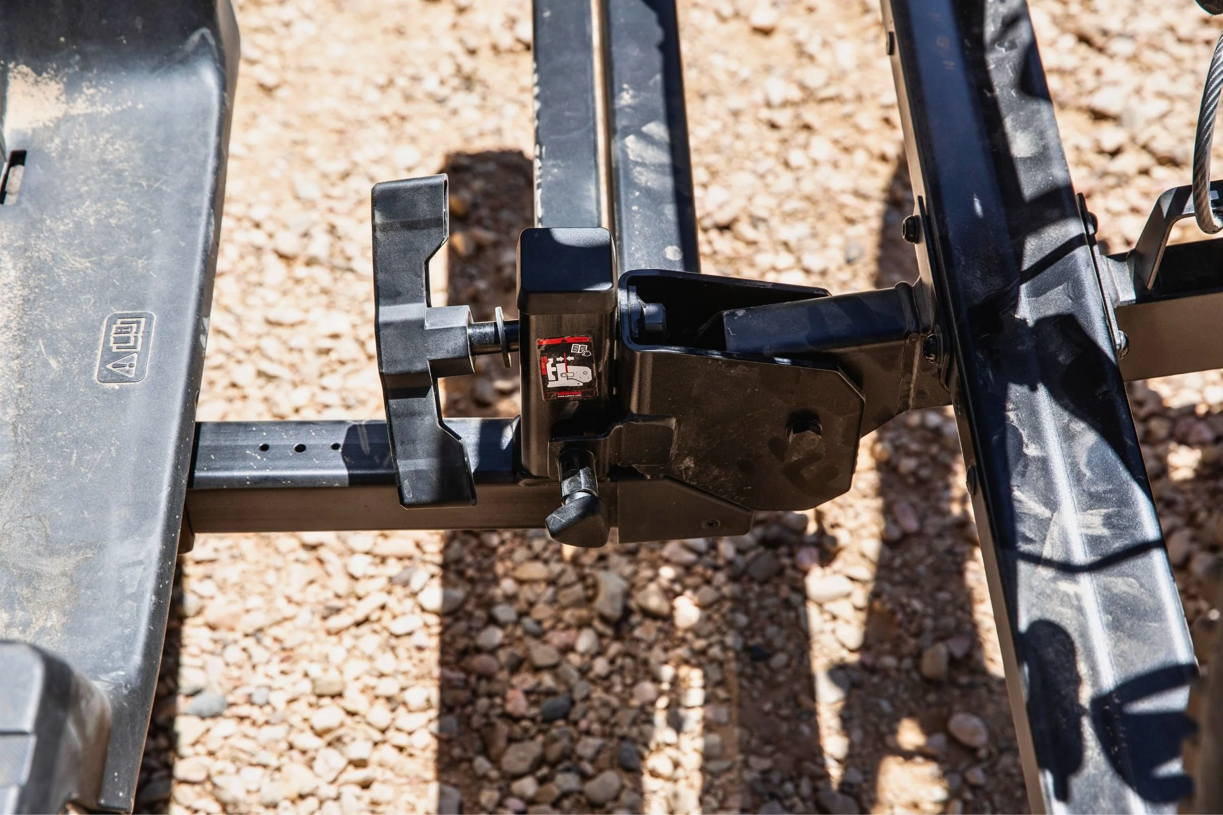 Close-up of the tilt-and-swing hitch mechanics on the Yakima StepUp Swing 2” Hitch Bike Rack.