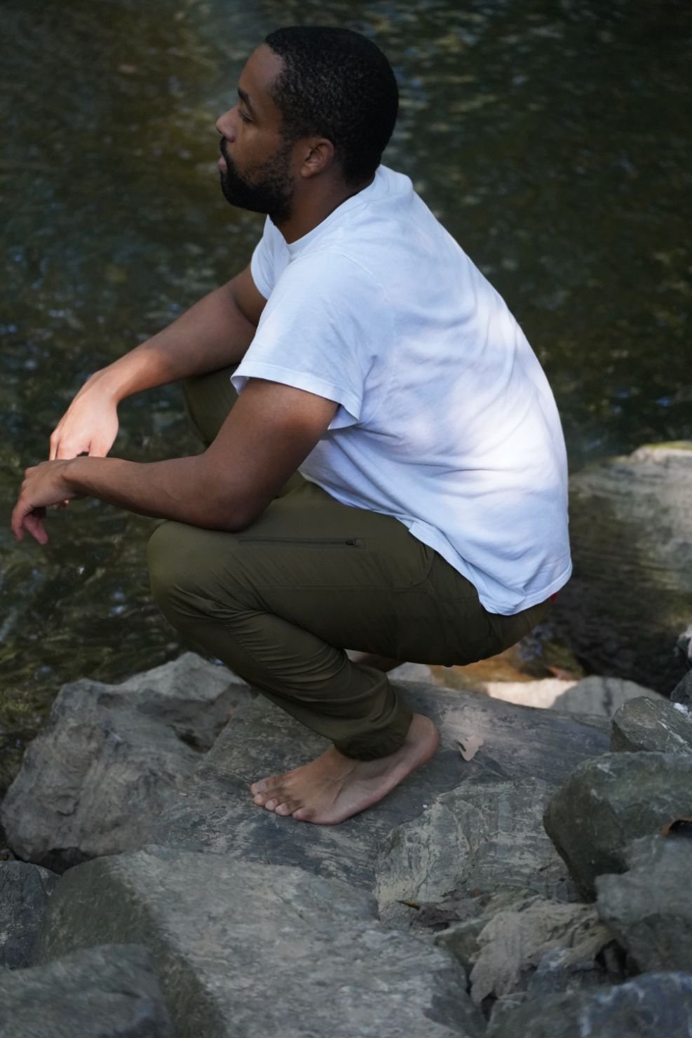 The author in a squat position to illustrate the stretchiness of the Outdoor Research Zendo hiking pants