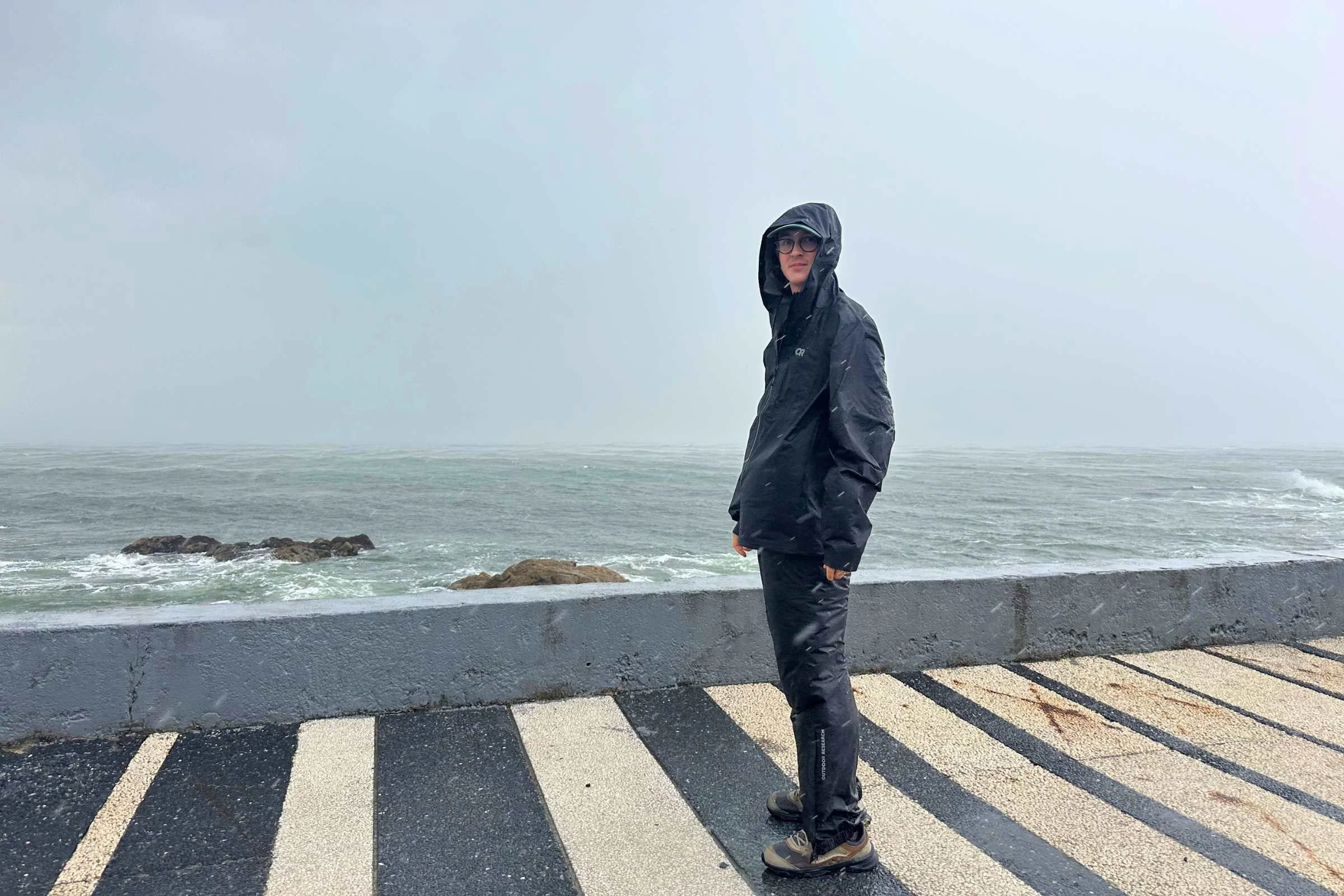 Side view of author in Outdoor Research Helium UL rain pants on sidewalk