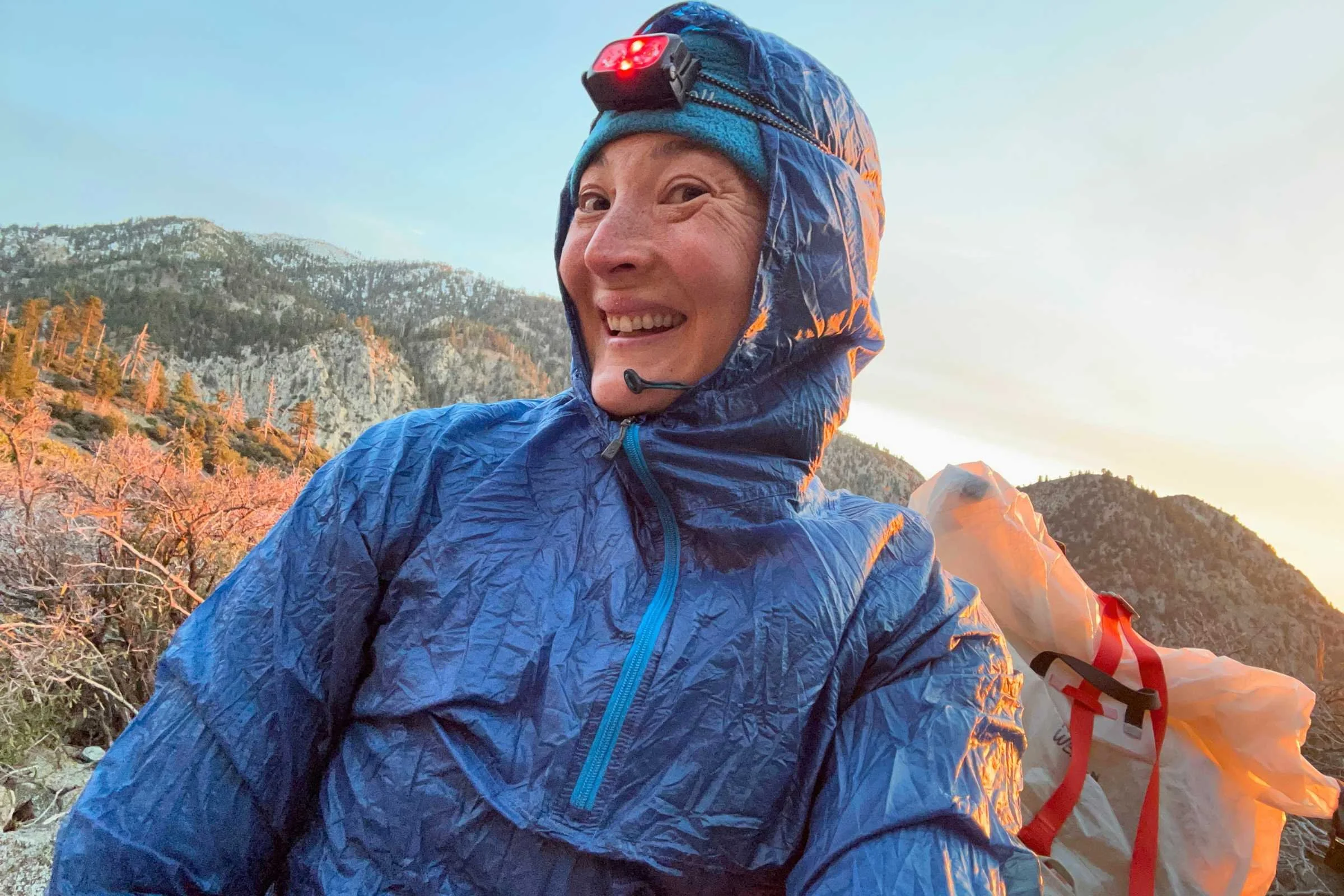 Backpacker wearing the Nitecore NU25 MCT headlamp in the early morning