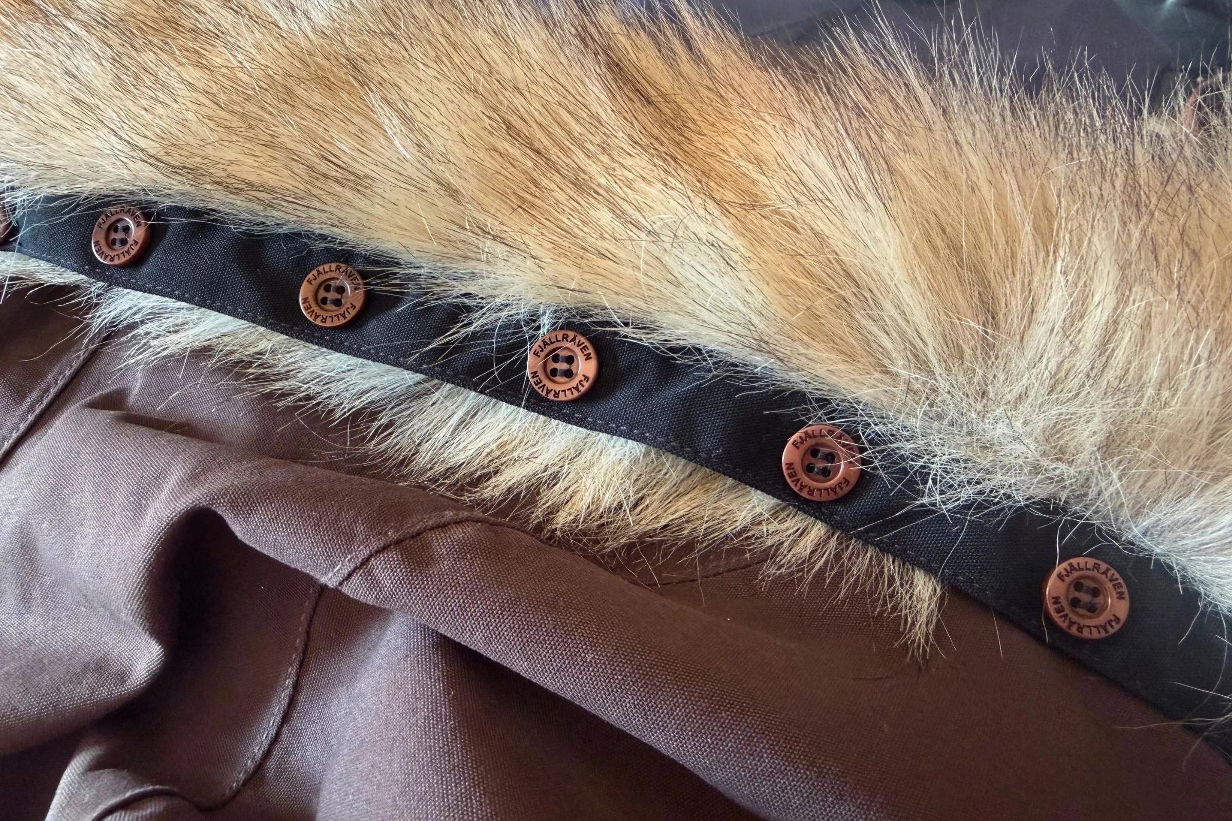 The faux fur trim removed — the many buttons mean it's secure, but it does take some time to re-attach.