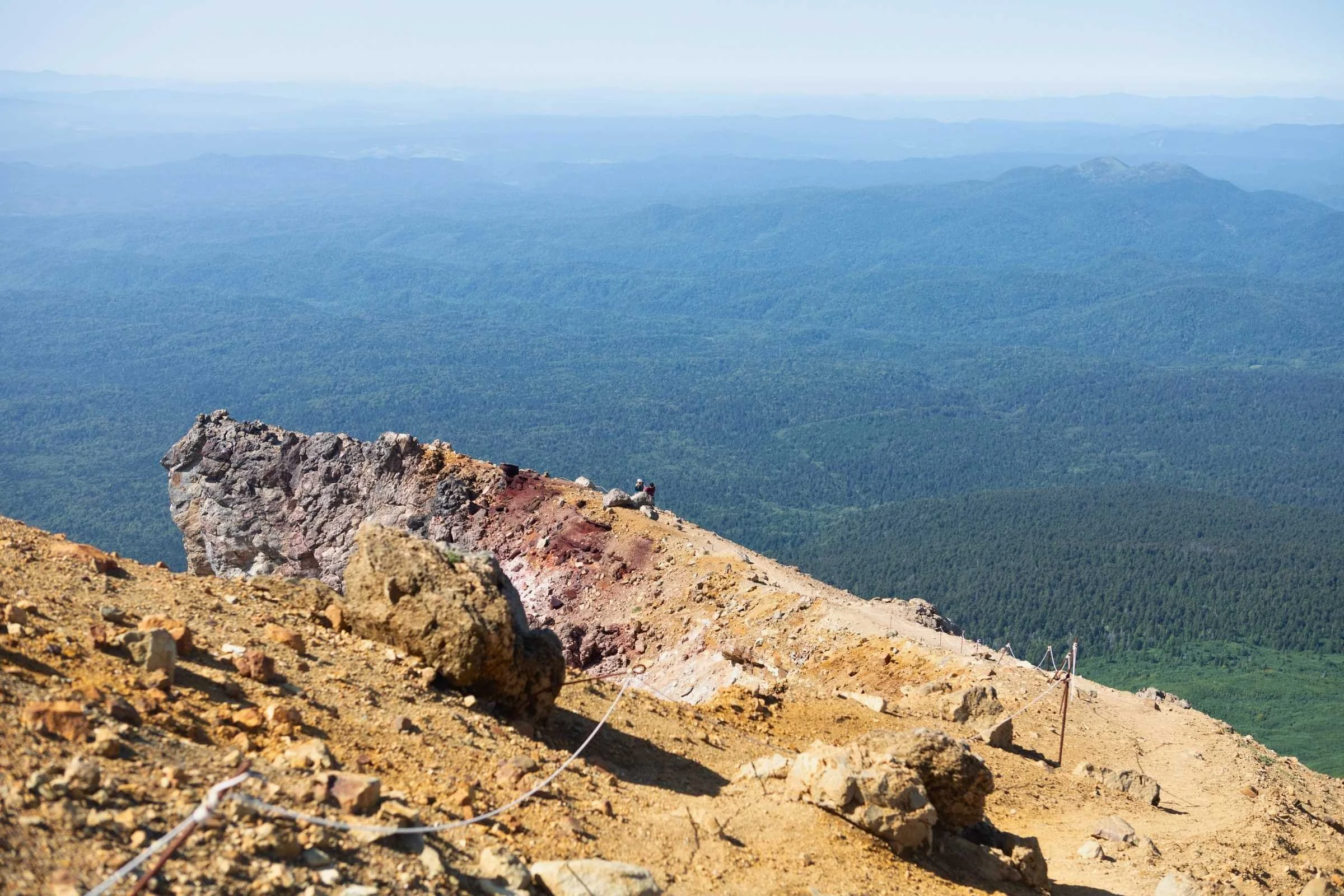 the author sitting on a large rock outcropping