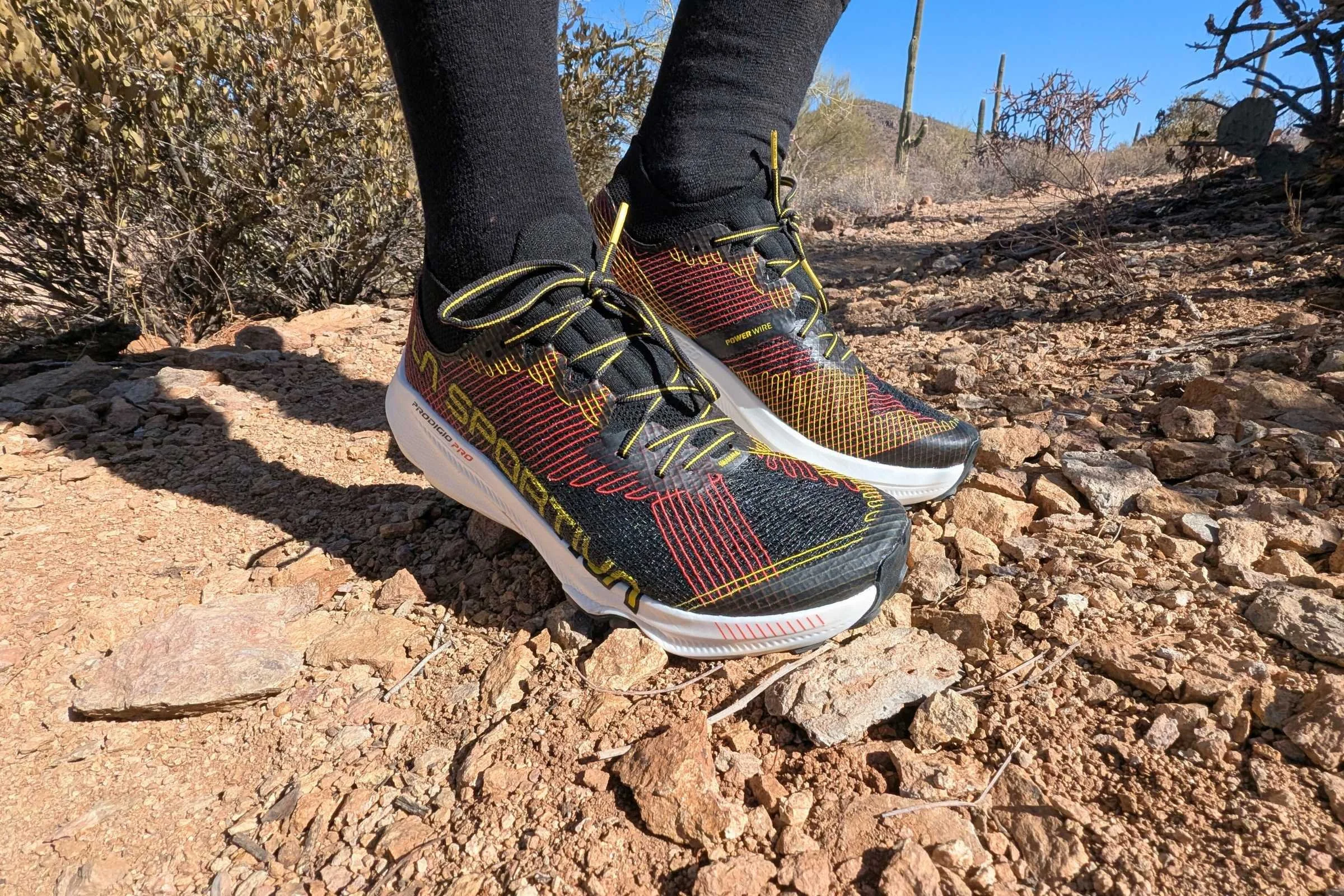 close up of the la sportiva prodigio pro trail running shoes on a runner’s feet