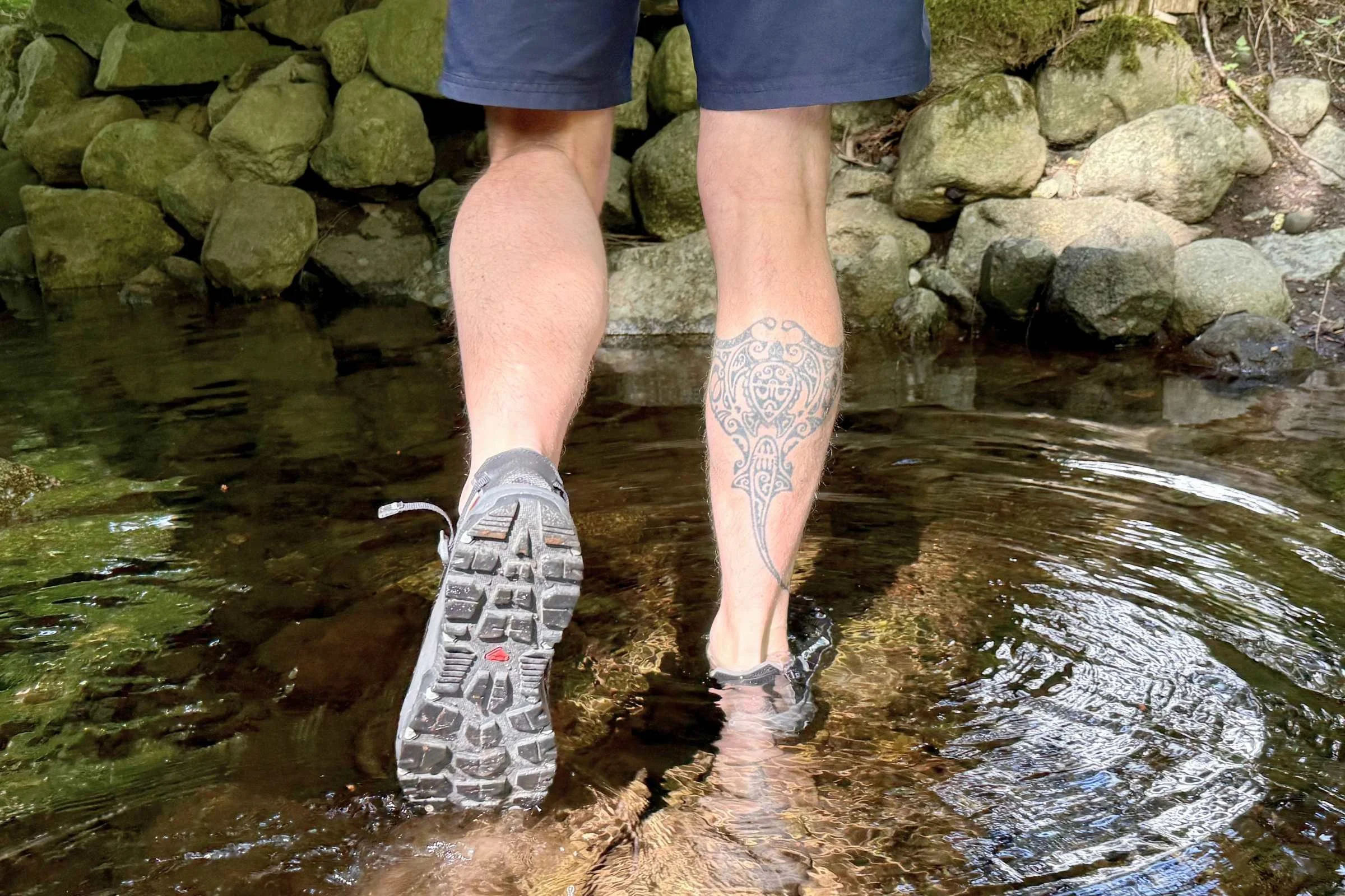 Wading in the water wearing the Salomon Techamphibian 5 water shoes