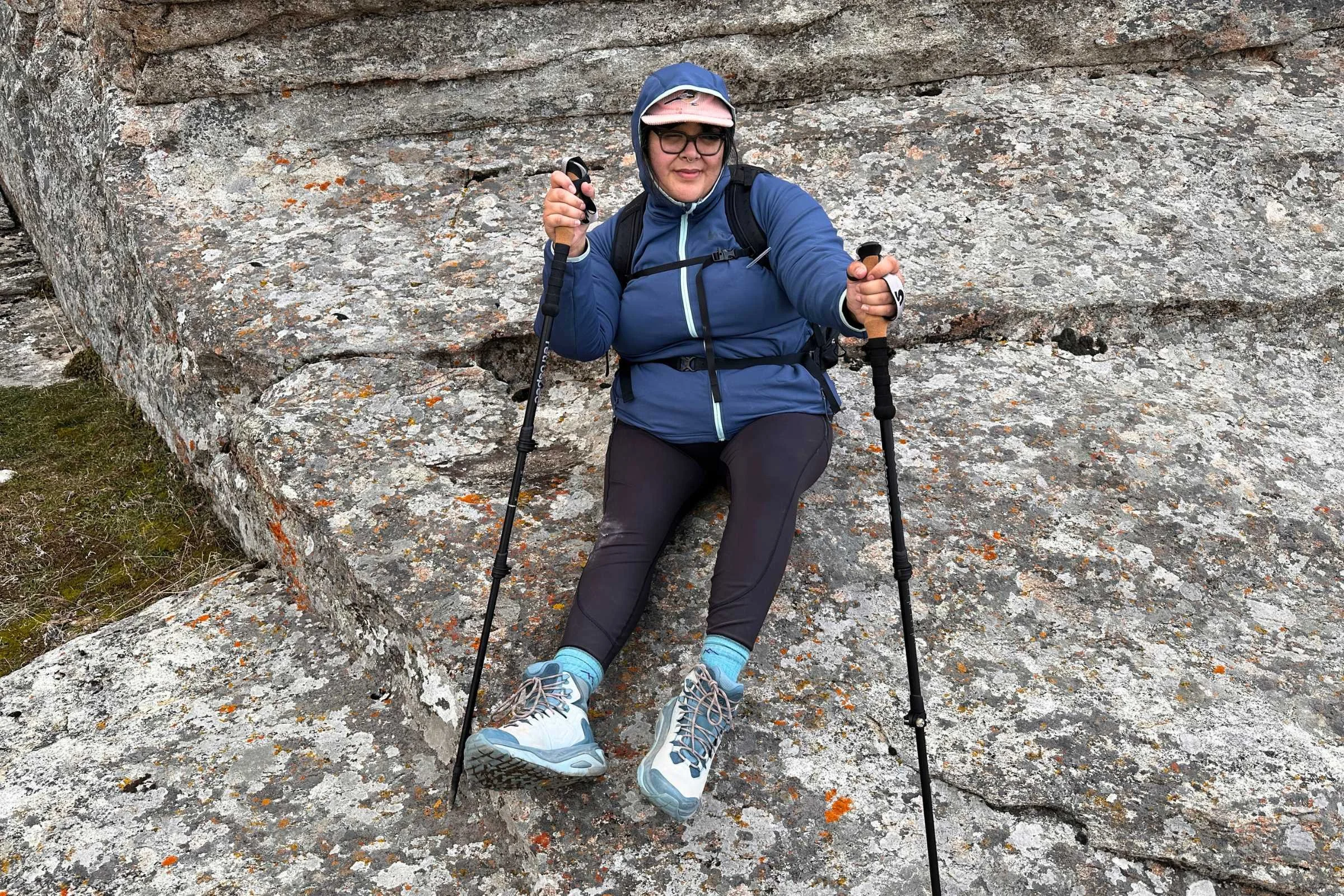 Wearing the Osprey Tempest while sitting on a rock formation.