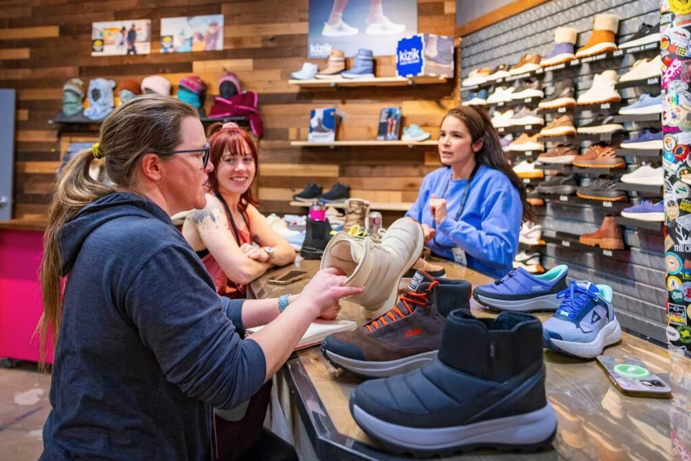 Treeline reviewers Sara and Becca checking out footwear at the Outdoor Market Alliance show.