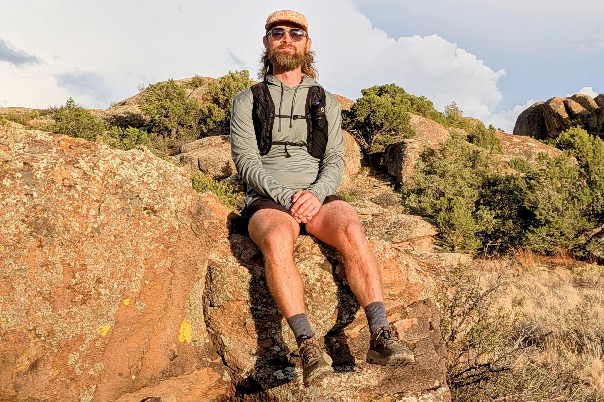 Author of the article Sam Schild sitting on a rock.