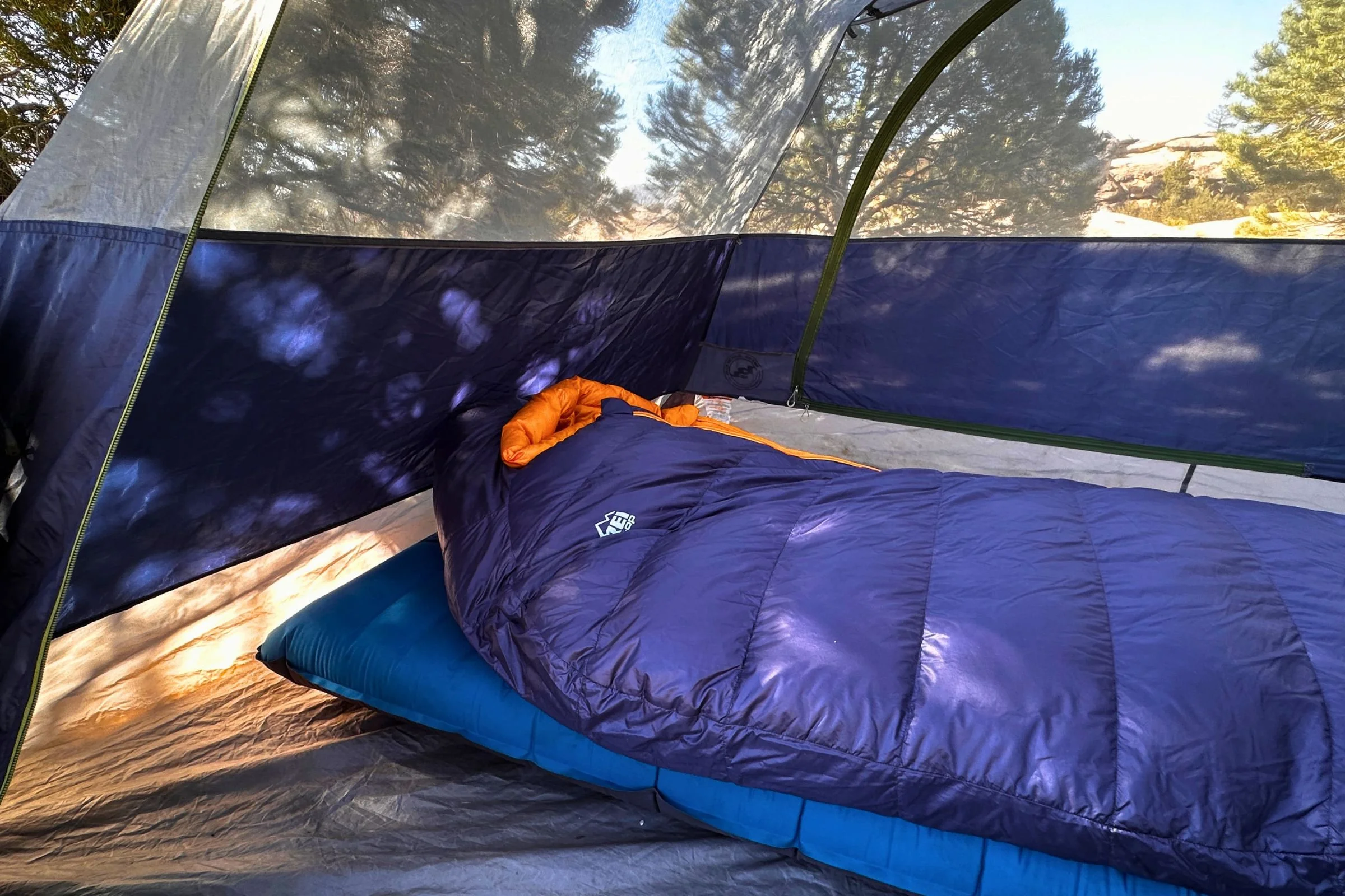 The REI Co-op Magma 30 sits empty on a NEMO Quasar sleeping pad inside a tent.