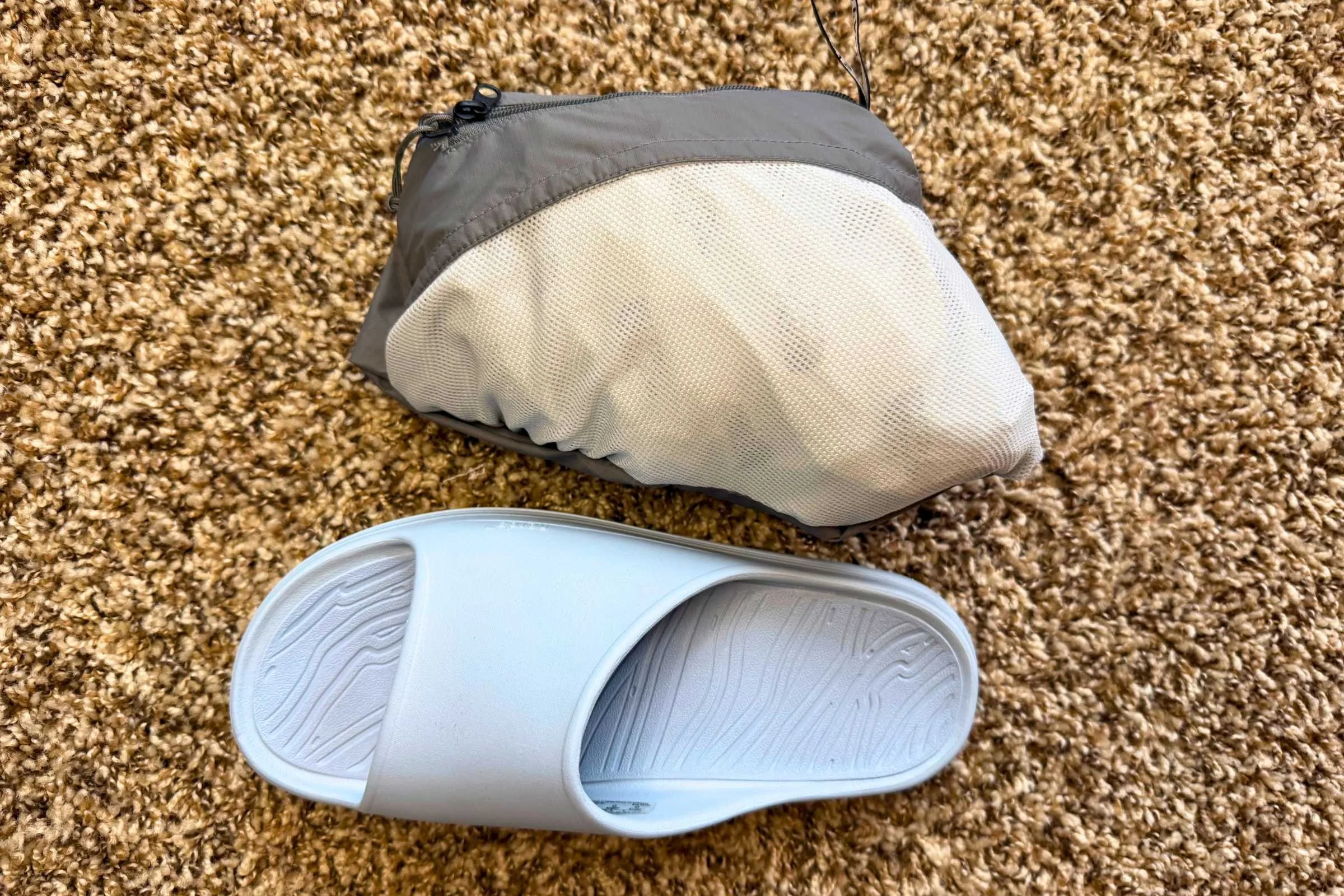 Norda 008 Recovery Slides: A pair of slides and a bag on the floor.