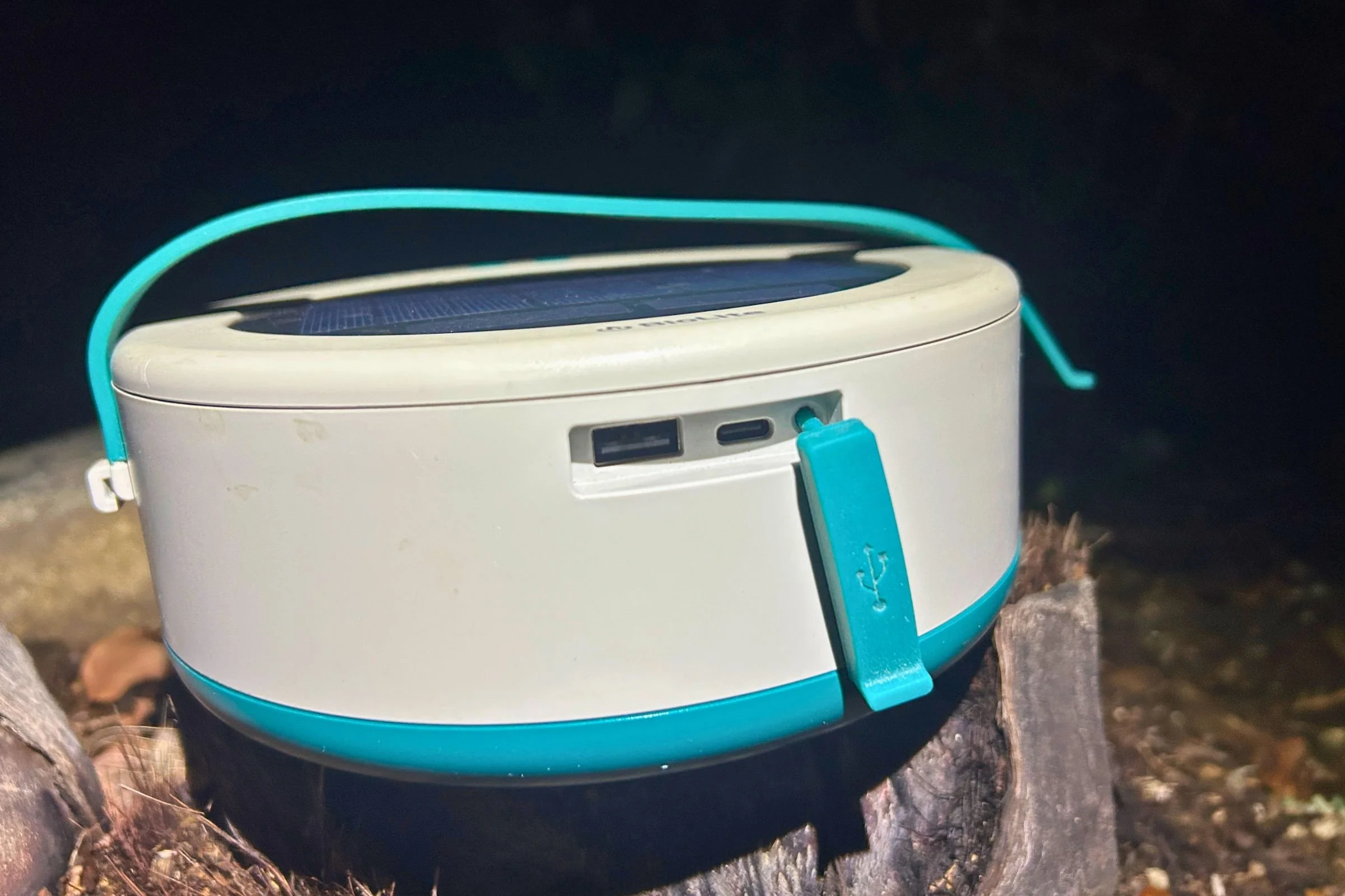 The BioLite Luci 44' Solar String Lights hub has a solar panel on top, a USB-C charging input, and USB-A and USB-C outputs beneath a protective flap.
