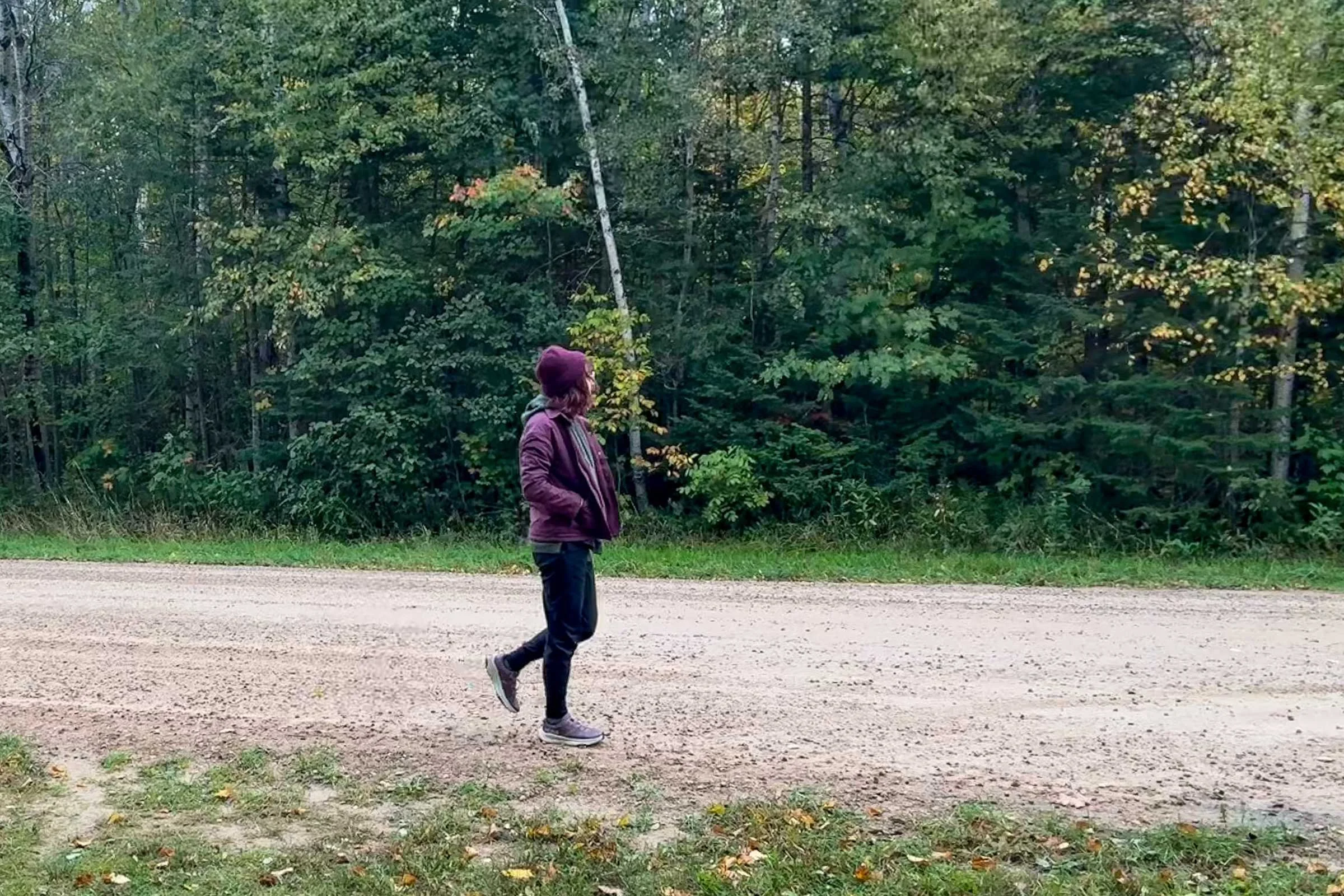 Woman walking in HOKA Transport 2 on dirt road