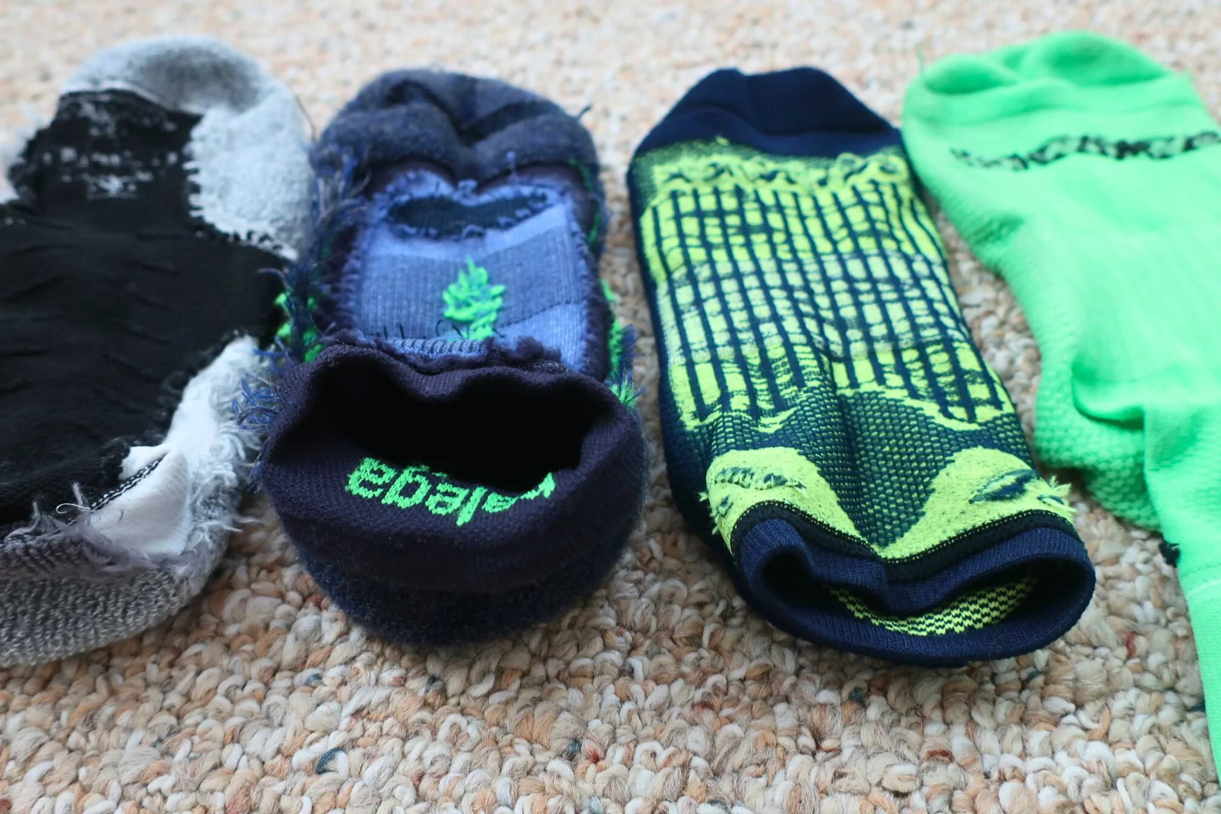 Varying construction of the inside of four of the socks we tested, from left to right: Thorlos Experia XCCU, Balega Blister Resist, Swiftwick Aspire Zero, Swiftwick Aspire Four. Padding can come with bulk.  Photo by Trey French