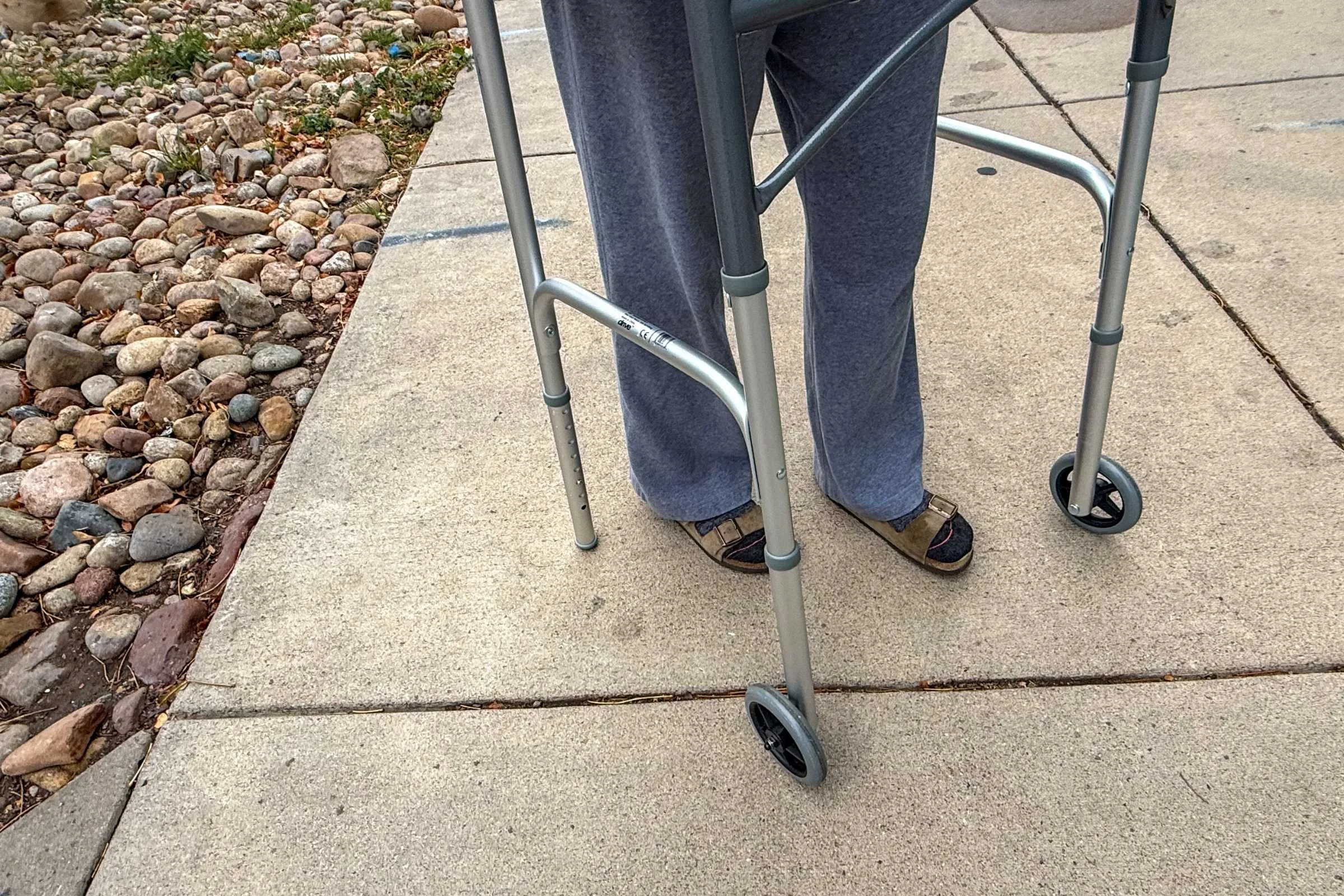 person wearing Birkenstock Arizona sandals with a walker