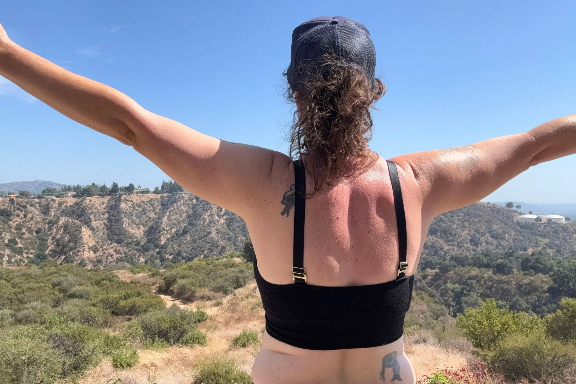 A back view of the author wearing a black BRANWYN Essential Supreme bra with the straps straight across the shoulders.