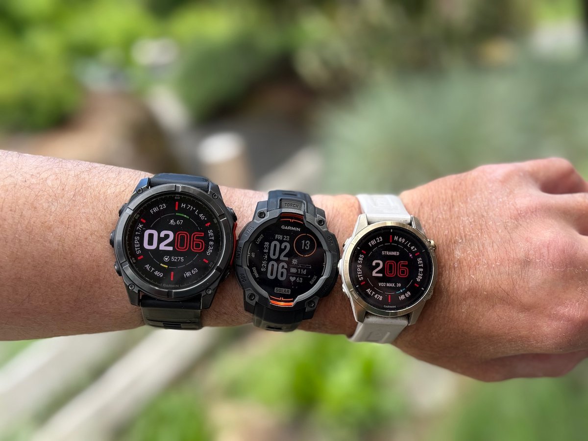 A person wearing 3 Garmin watches - the fenix 8, the Instinct 3, and the Epix Pro Gen 2