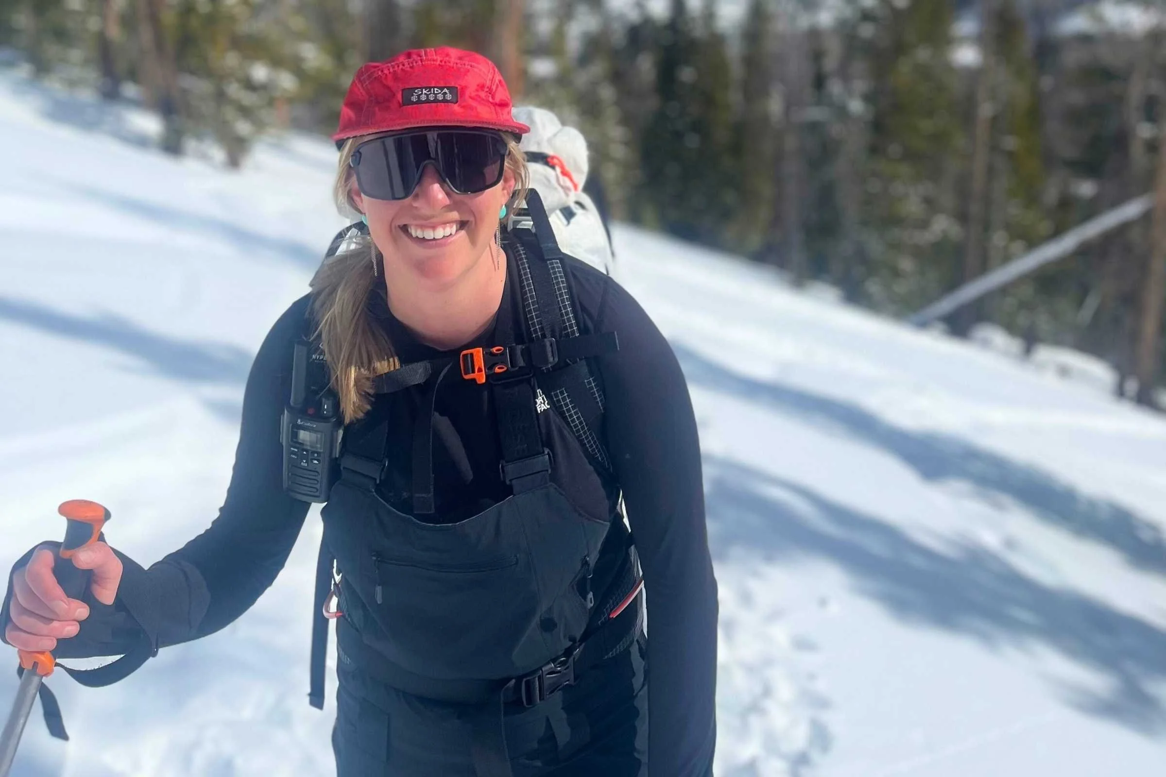 The author wearing an older version of the Hemispheres bibs on a ski tour, with her beacon in the dedicated chest pocket. Photo by Jon Stockwell.