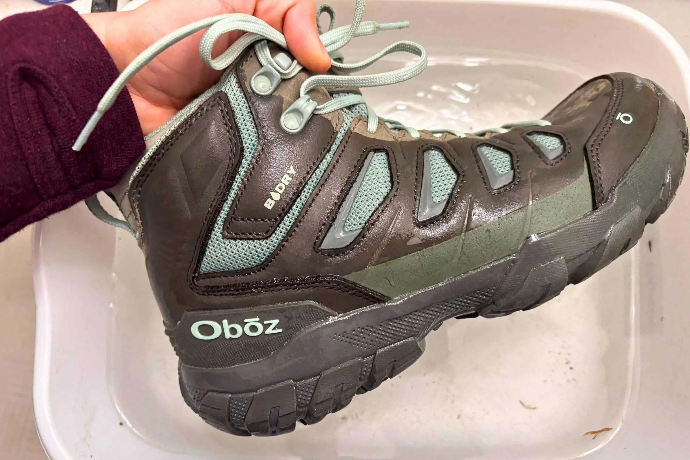 the Oboz Sawtooth X Mid hiking boots in a bucket of water
