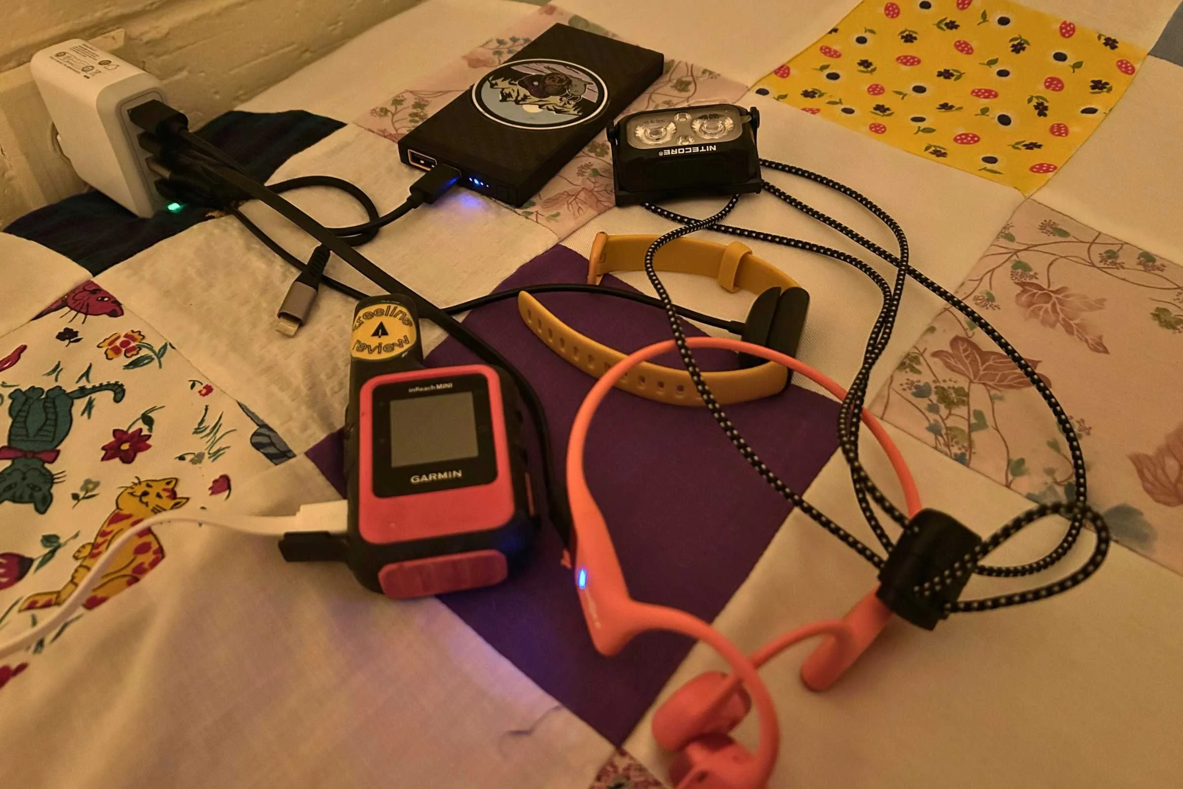 Charging the Nitecore NU25 MCT at a hotel on a town day on the Ouachita Trail alongside other electronics.