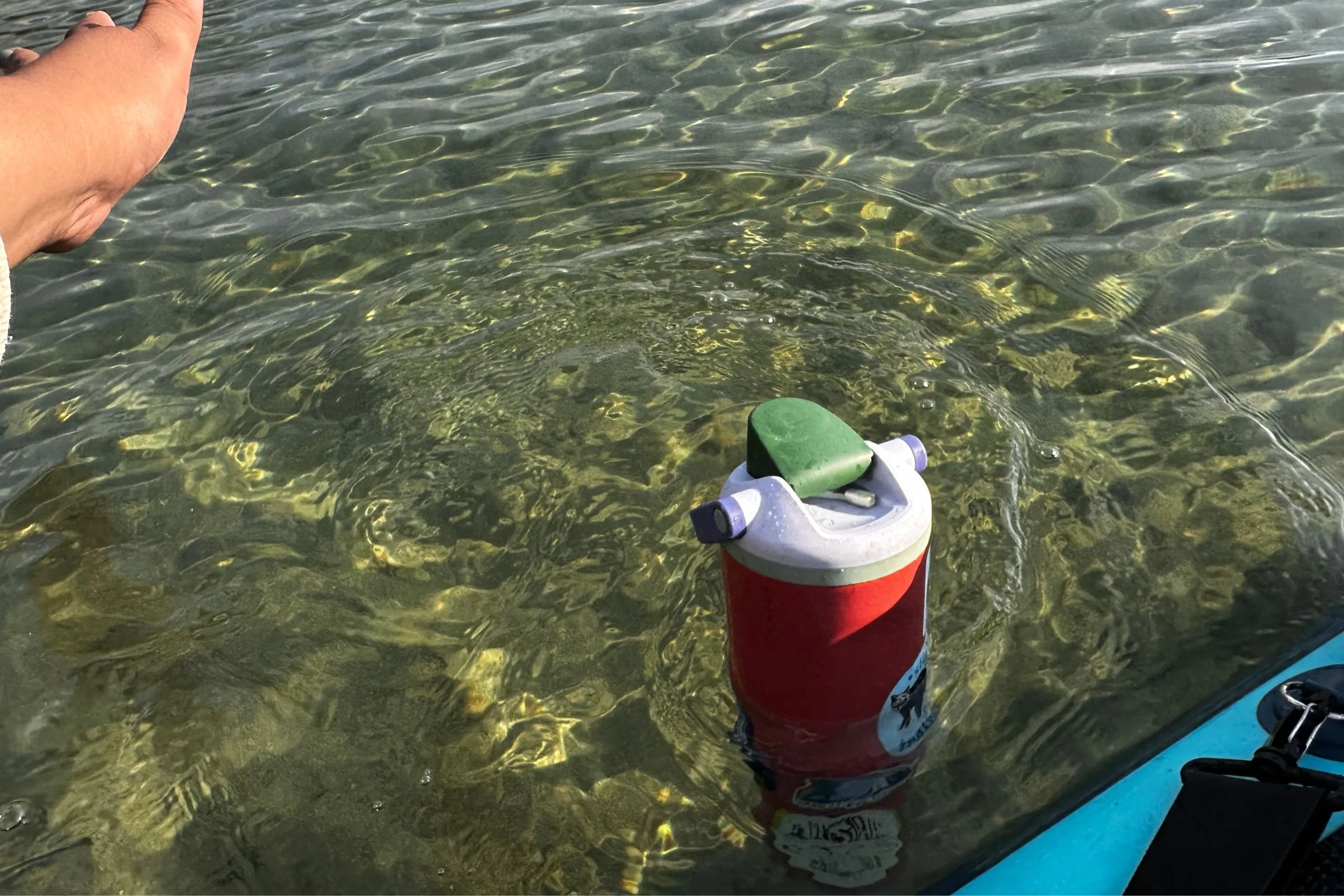 The Owala FreeSip Sway bobbing upright after falling off of a paddleboard.