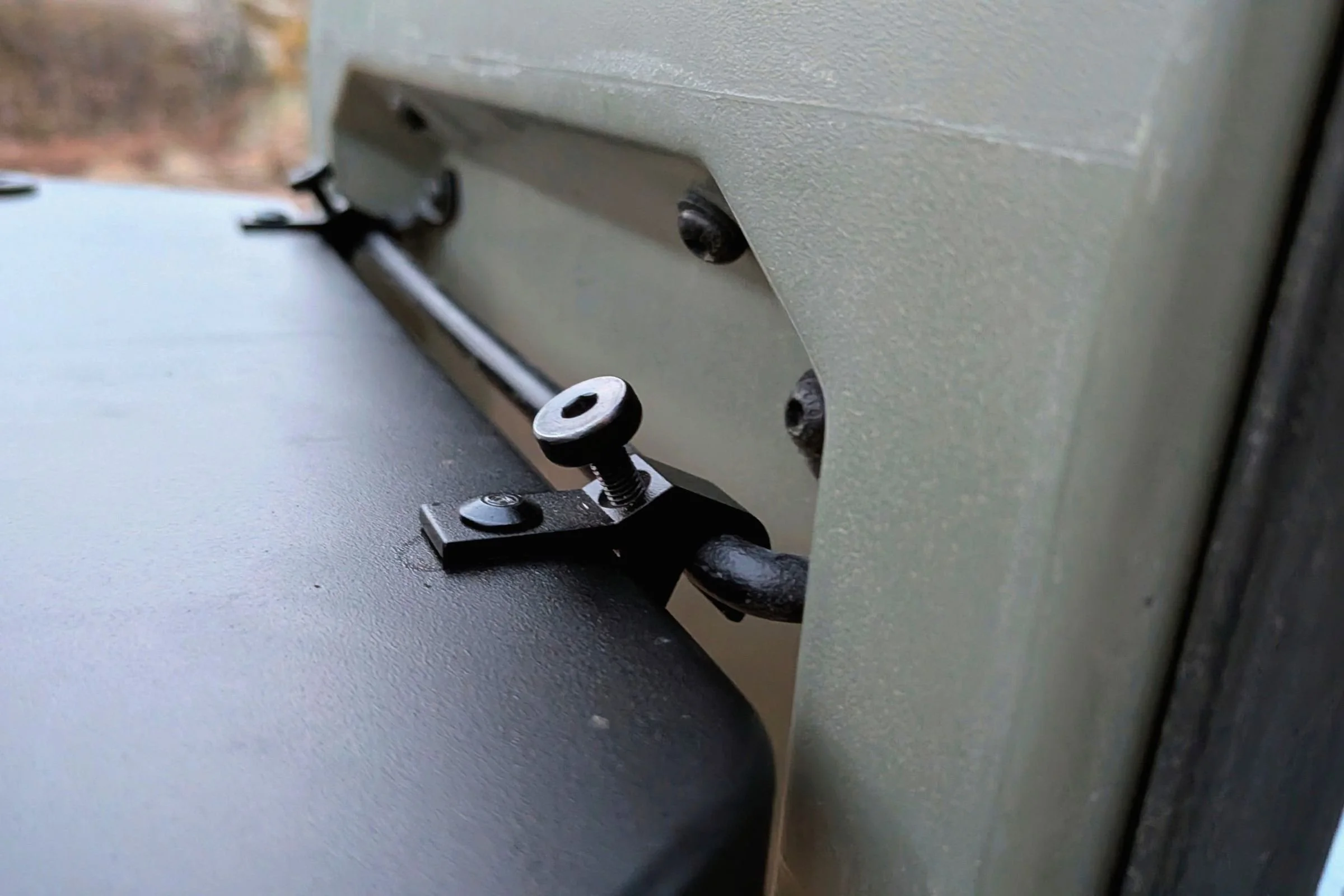 Close-up of the metal attachment bar used to secure the Yakima EXO OpenRange side table to a vehicle.