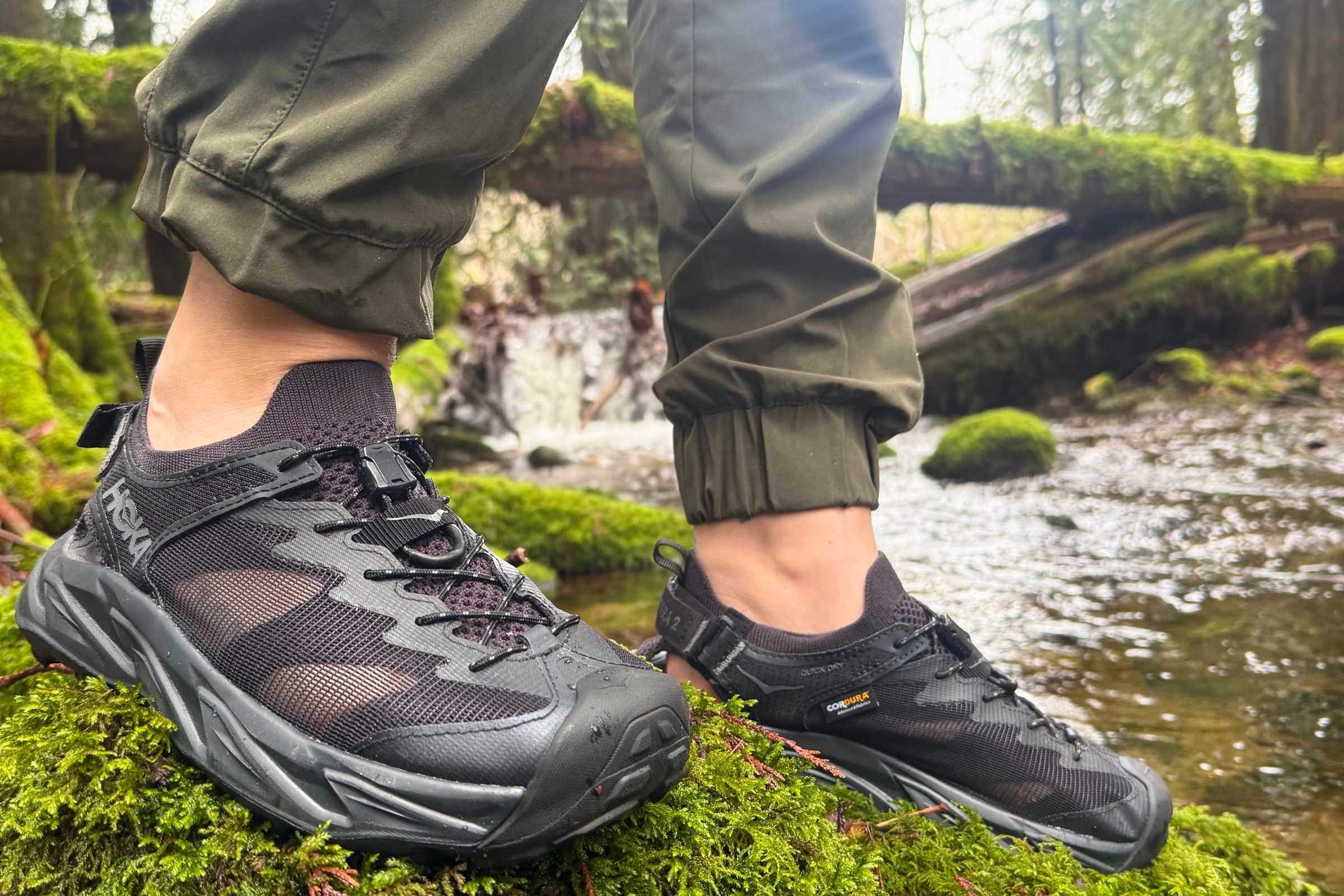 Person crossing stream wearing the hybrid water shoes HOKA Hopara 2