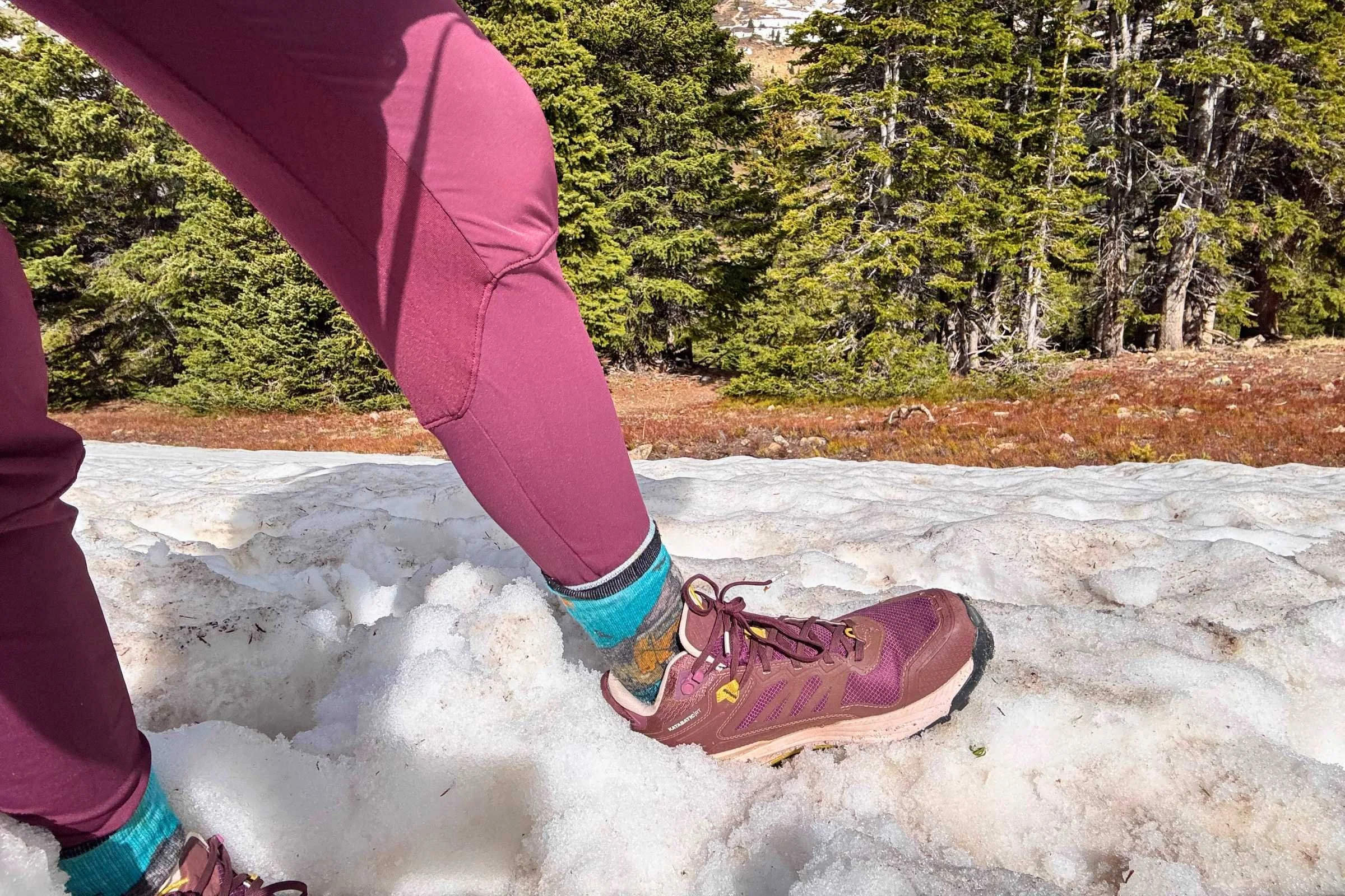 A person testing the Oboz Katabatic RT Mid GTX hiking boots on a snow covered trail