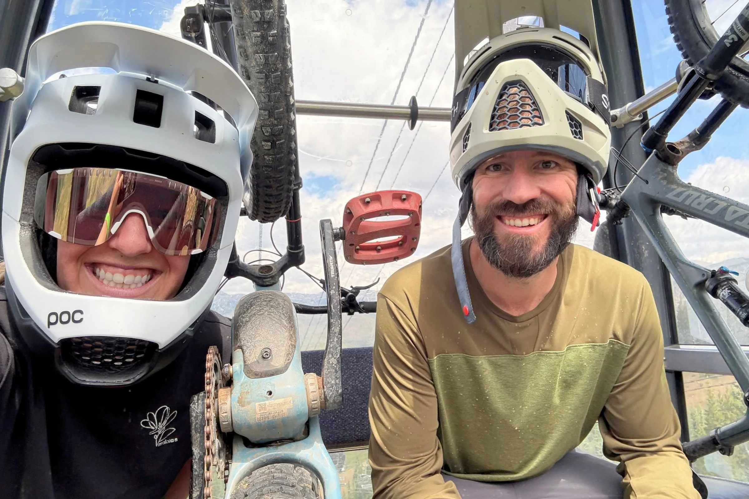 Two people next to their mountain bikes at Keystone, one wearing a POC helmet, and the other wearing the Smith Hardline helmet.
