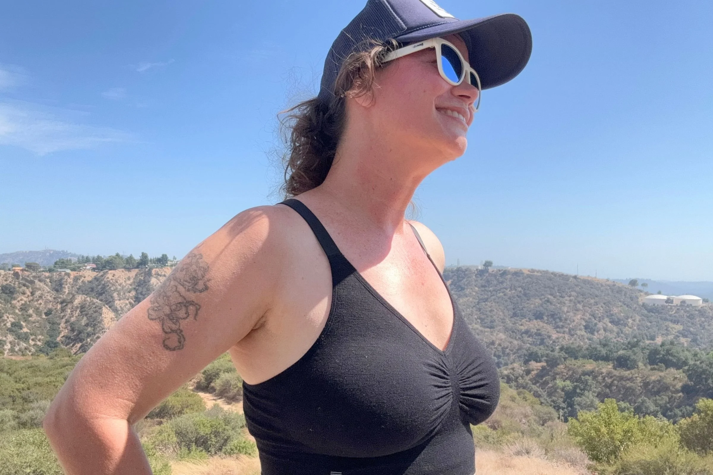 A side view of the author wearing a black BRANWYN Essential Supreme bra.