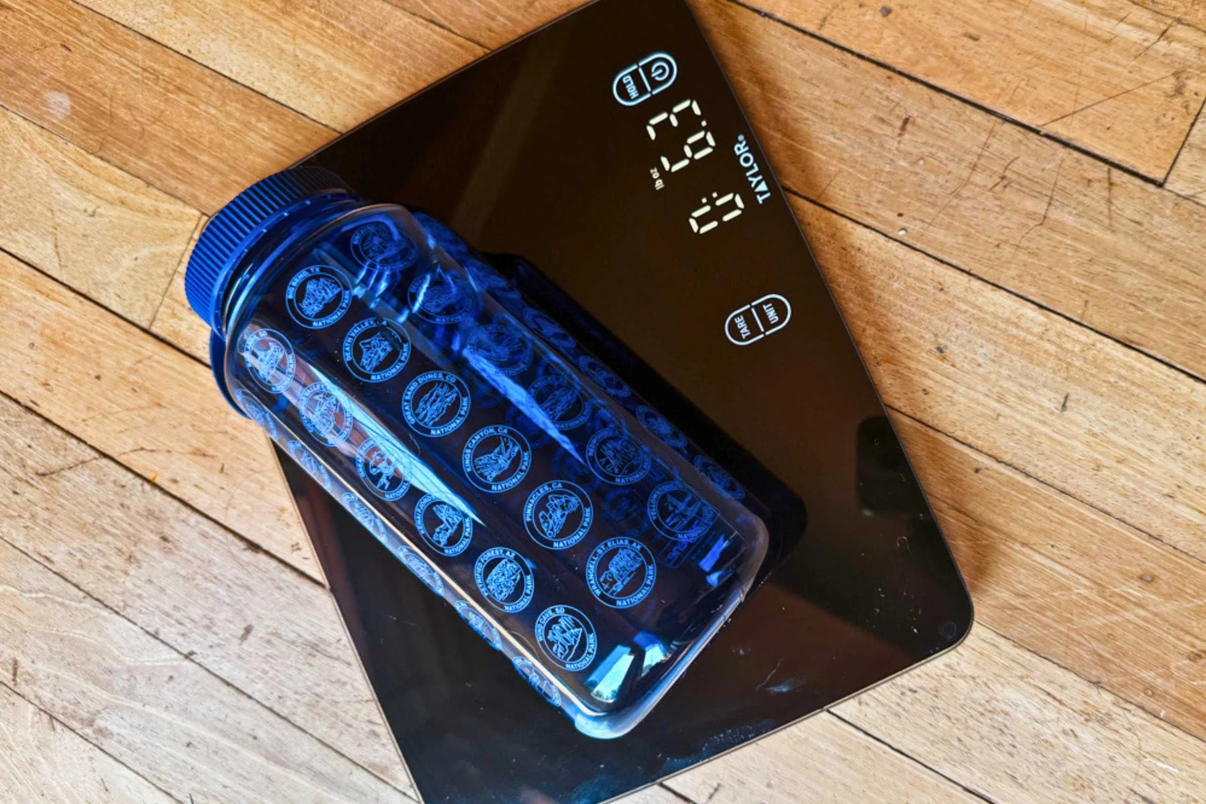 A lightweight travel water bottle next to a coin or hand for scale, showing its minimal size