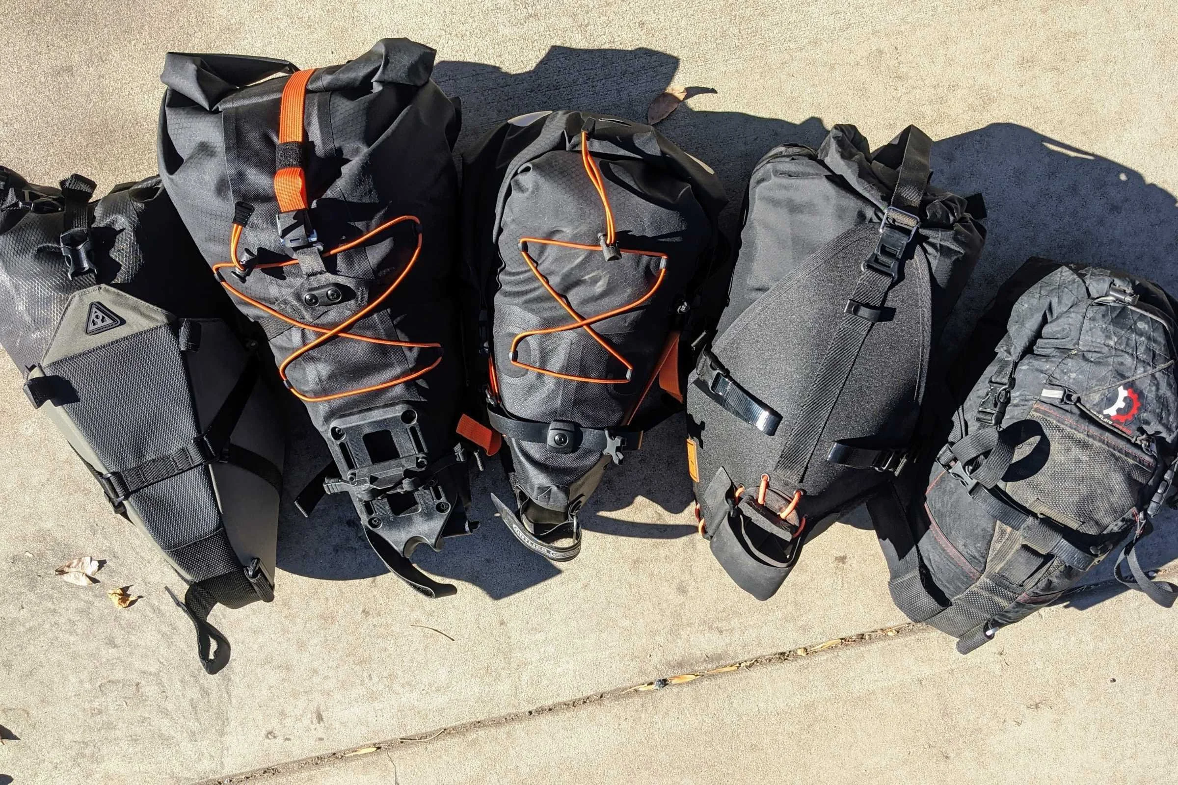A line-up of some of the bikepacking saddle bags we tested side-by-side.