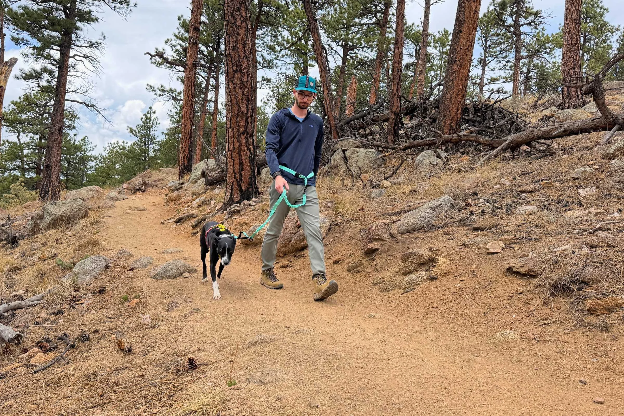 Dog hooked to a Iyoshop hands free leash and man walking on a wooded trail