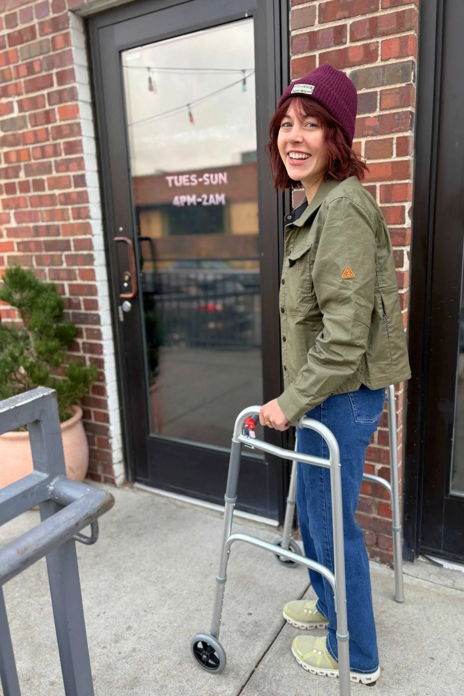 woman walks outside with a walker while wearing on cloud 6 shoes