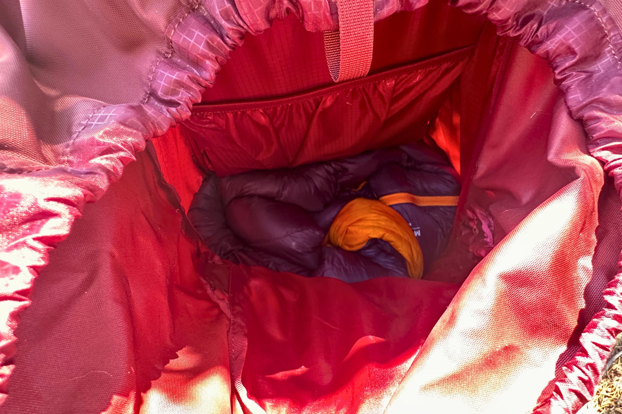 The REI Co-op Magma 30 fits into the sleeping bag compartment of a 60 L Gregory pack when stuffed in.