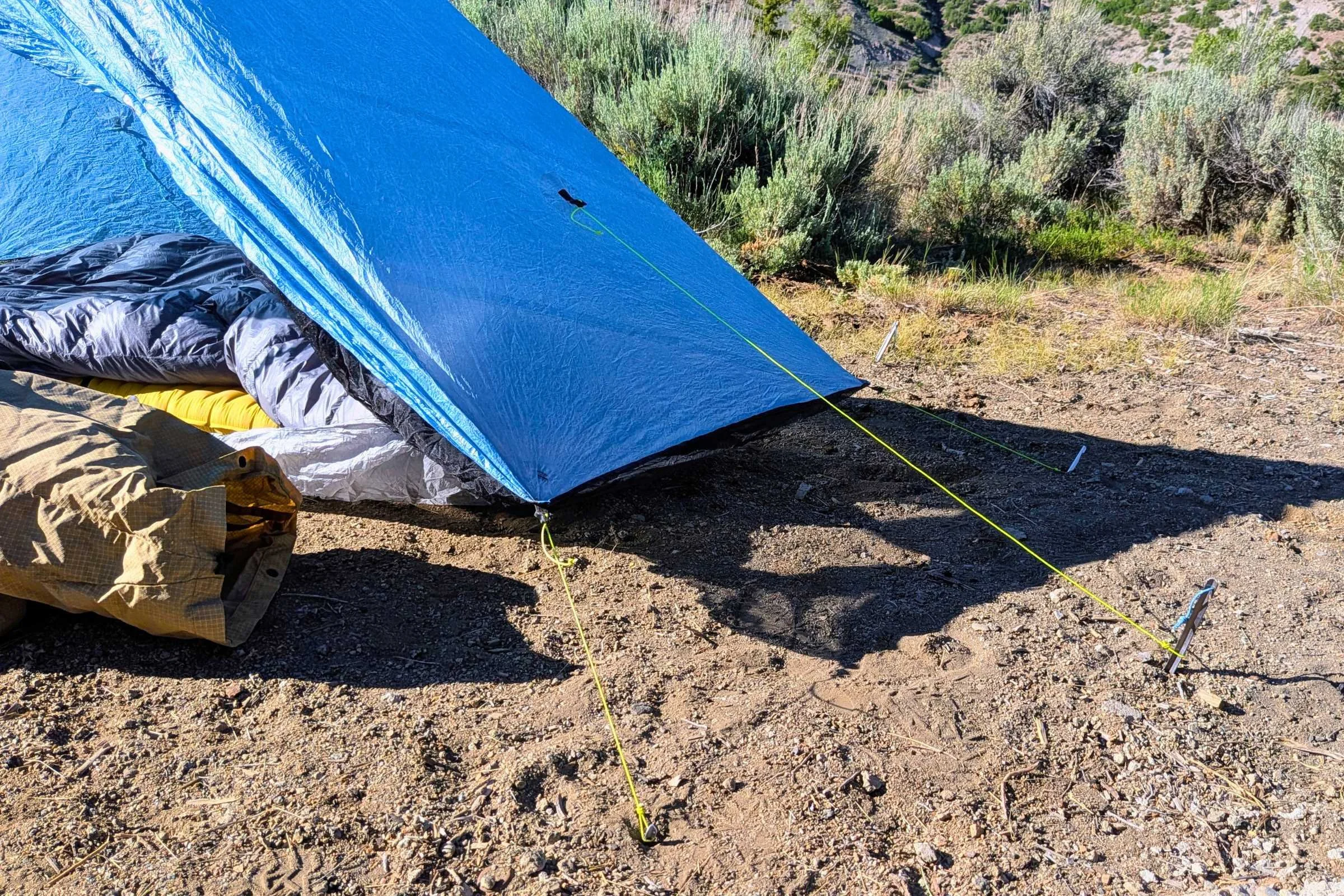 Zpacks Hexamid Ultralight Tent set up on the ground next to a gear bag.